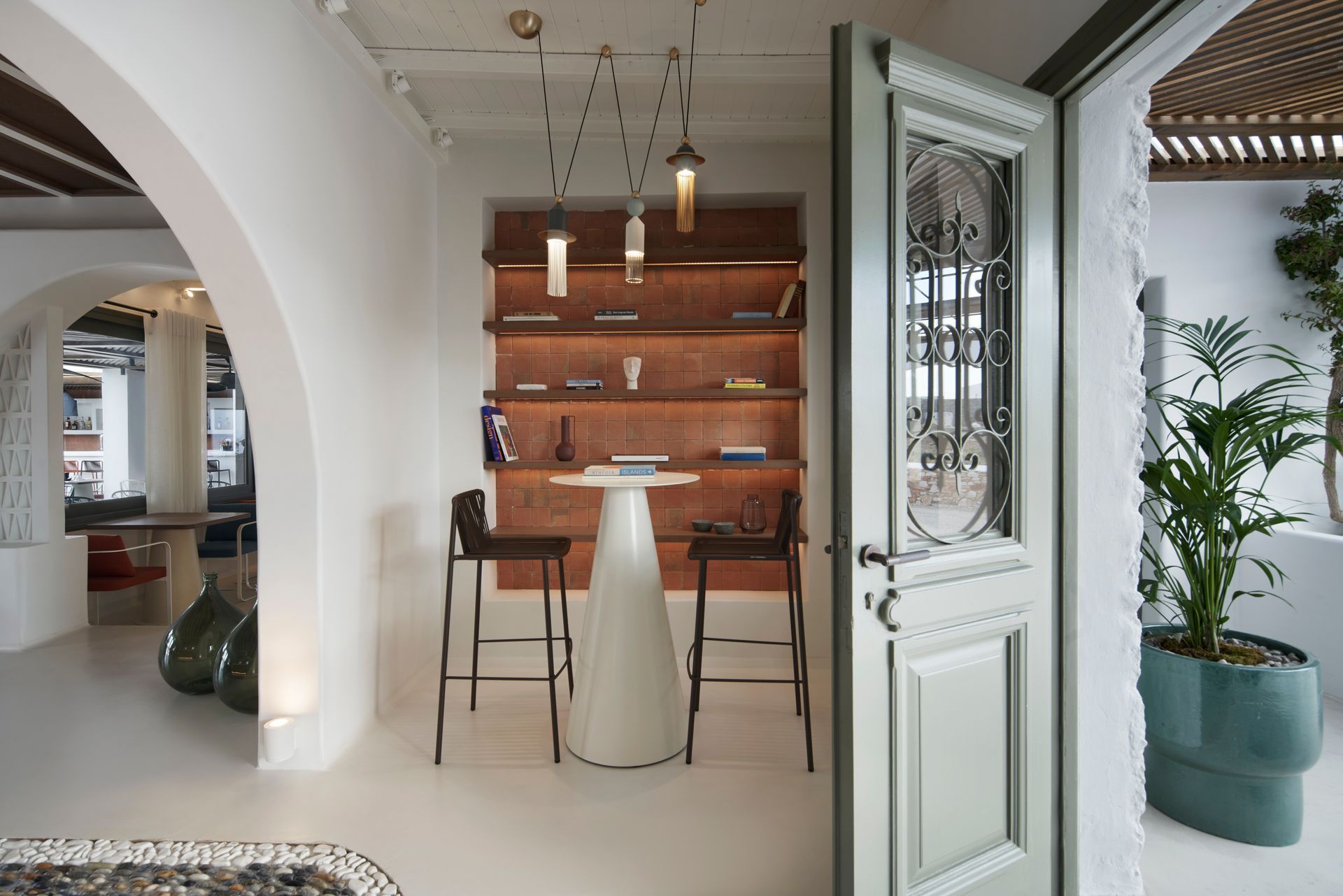 A room with a table and chairs in it at Andronis Minois Hotel in Paros, Greece.