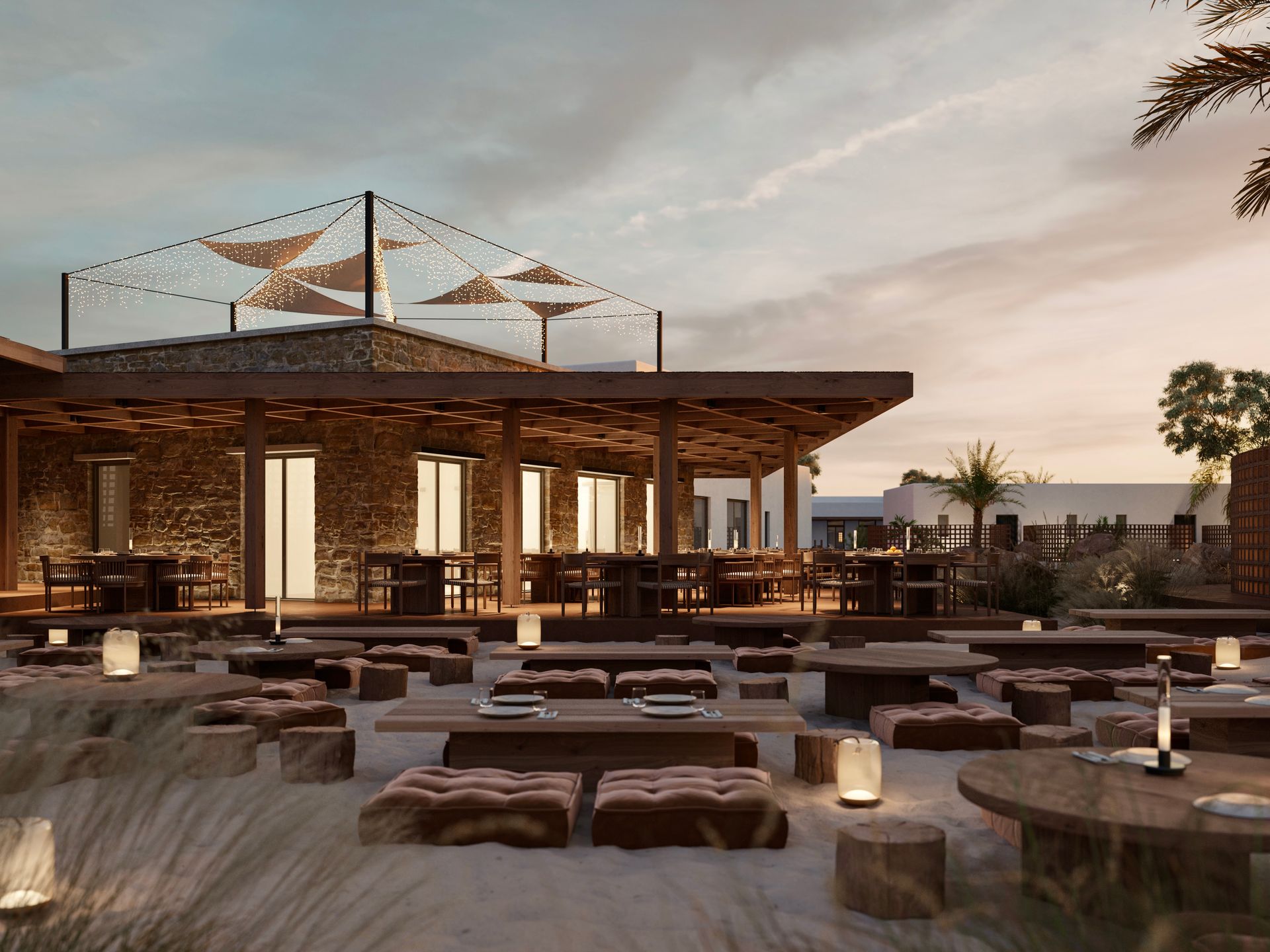 A large building with a lot of tables and chairs in front of it at Laguna Coast Resort in Naxos, Greece.