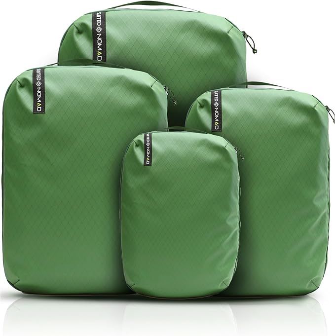 A group of green bags with the word nomad on them