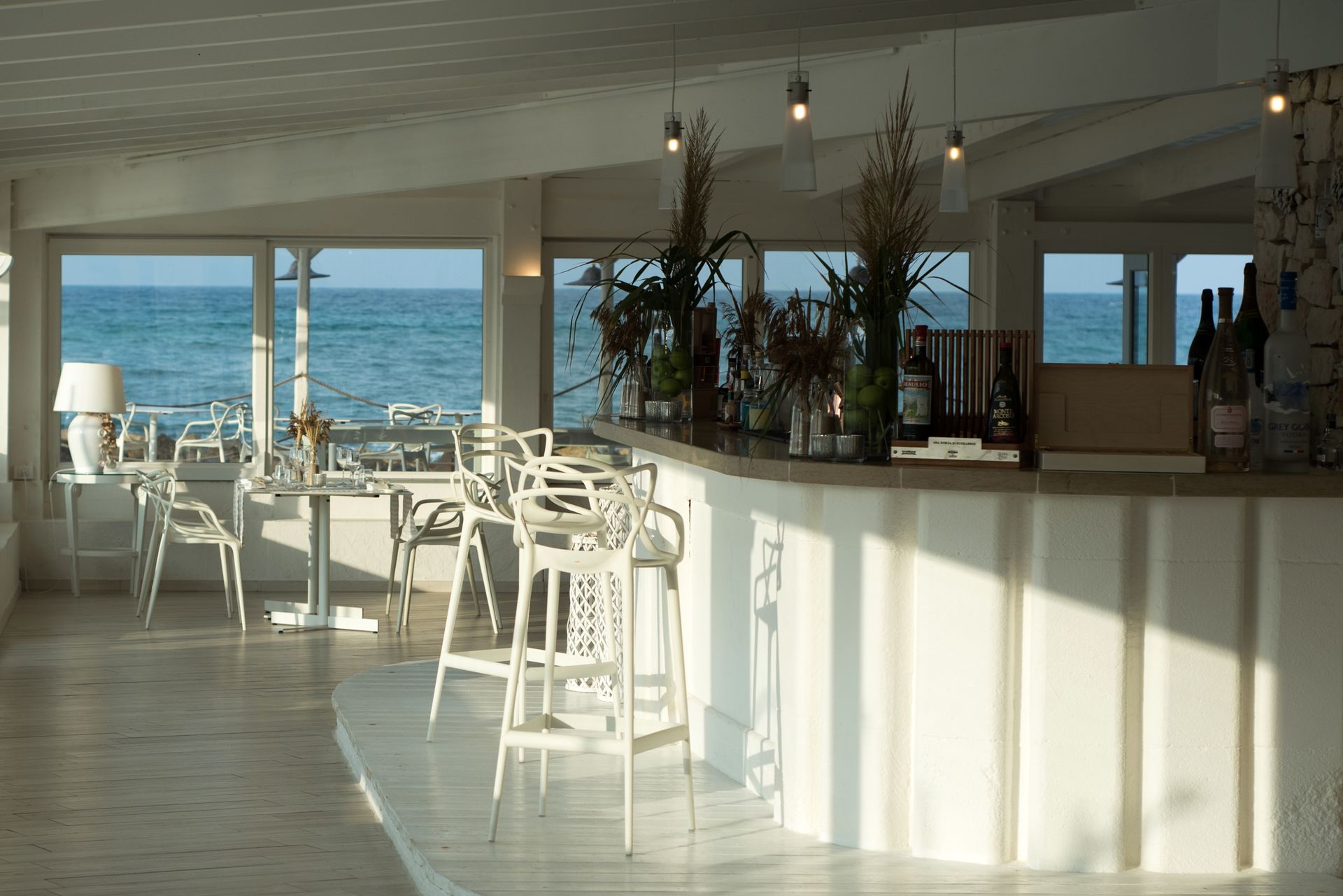 A bar with a view of the ocean in a restaurant at La Peschiera Hotel in Puglia, Italy.