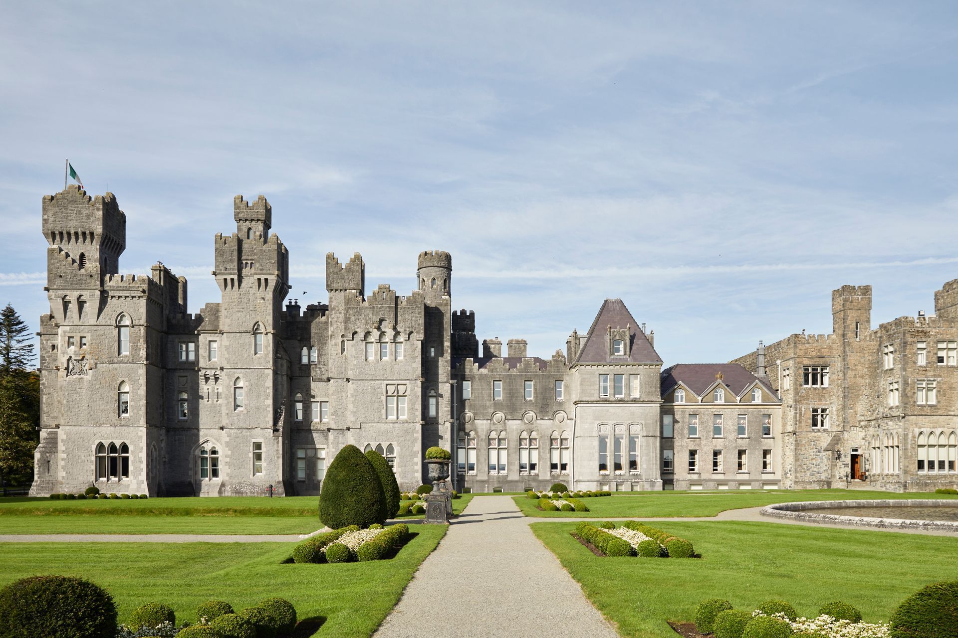 A large castle hotel with a path leading to it at the Ireland Red Carnation Hotel. 