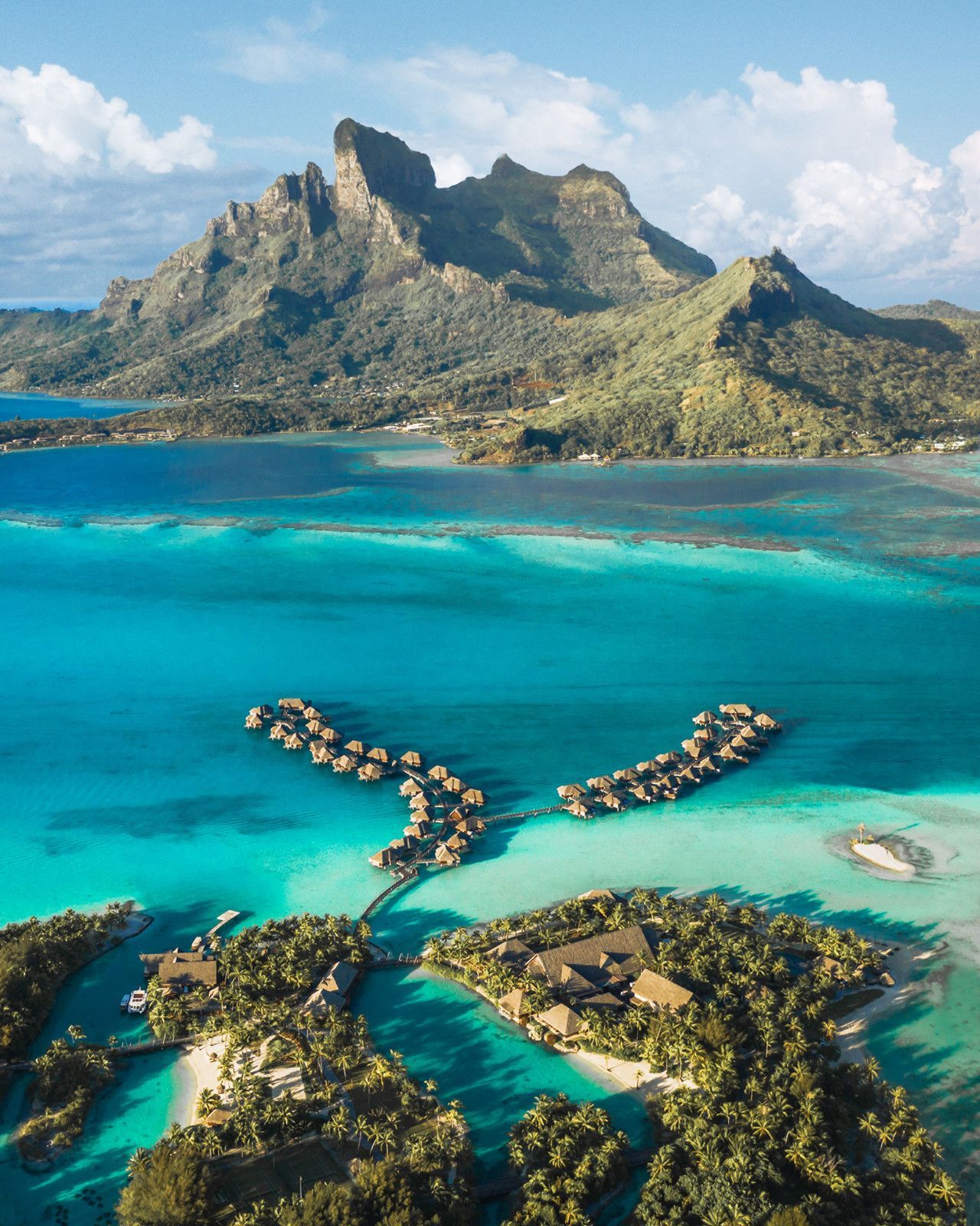 An aerial view of over-the-water bungalows at Four Seasons Resort in Bora Bora. 