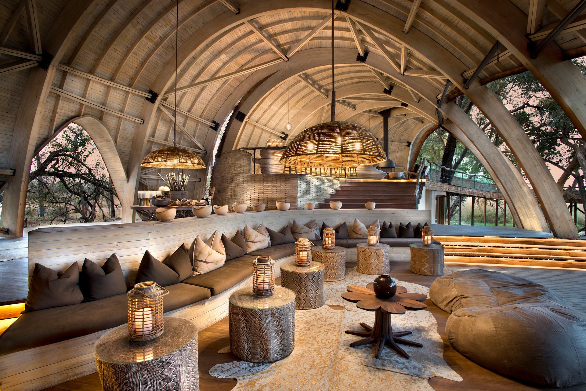 A large room with a lot of furniture and tables in a lodge in Africa.