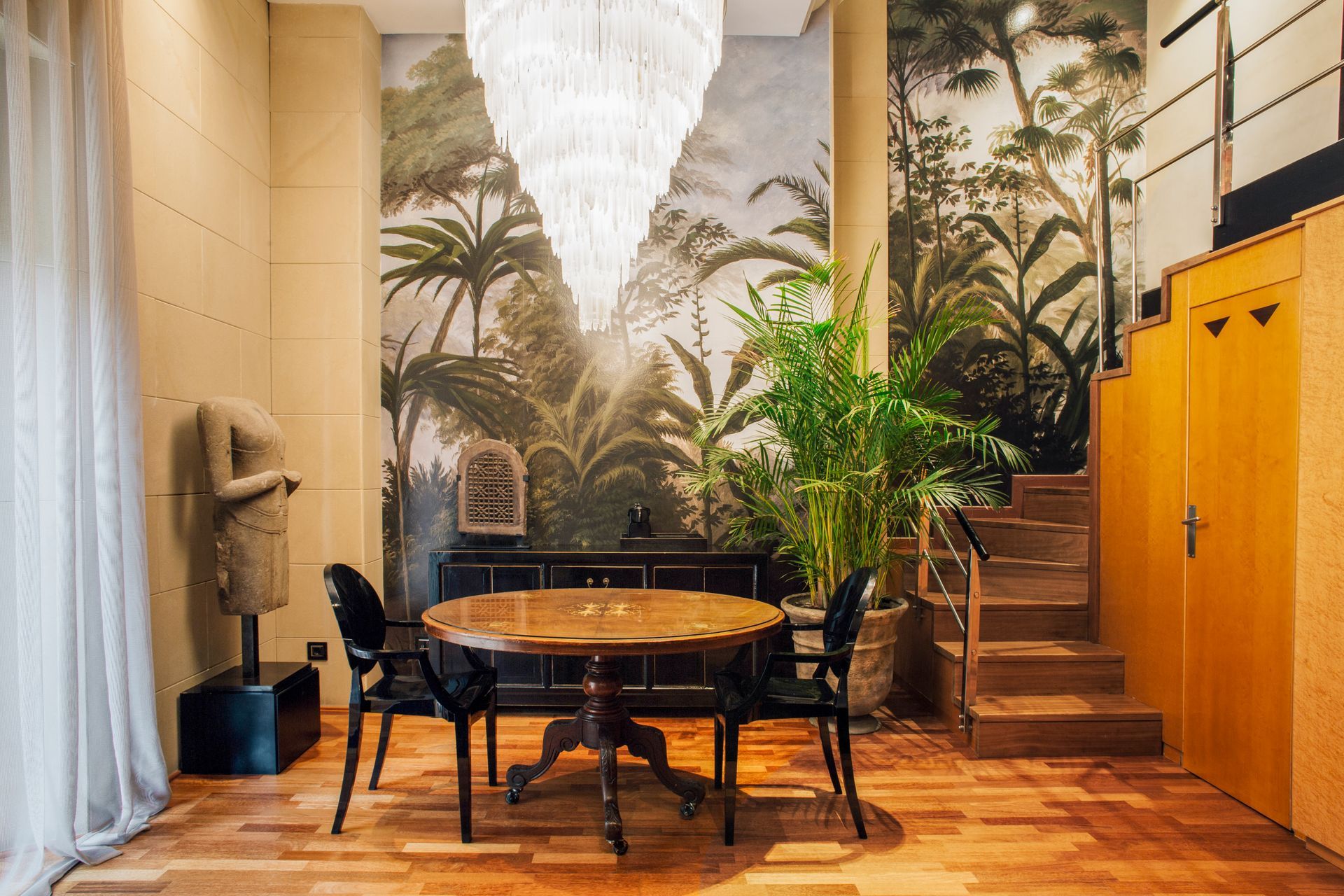 A dining room with a table and chairs and a mural on the wall at Claris Hotel & Spa in Barcelona, Spain.