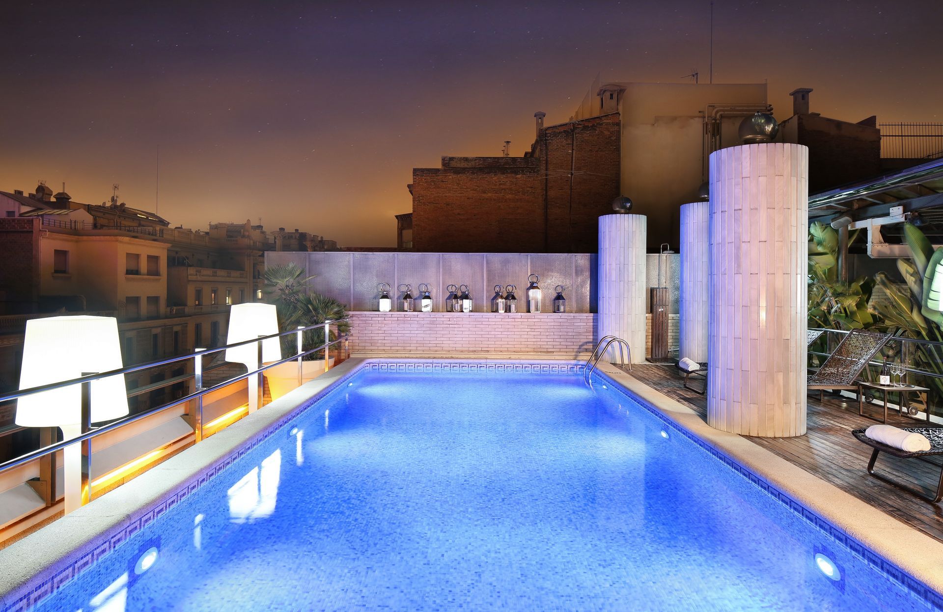 A large swimming pool is lit up at night at Claris Hotel & Spa in Barcelona, Spain.