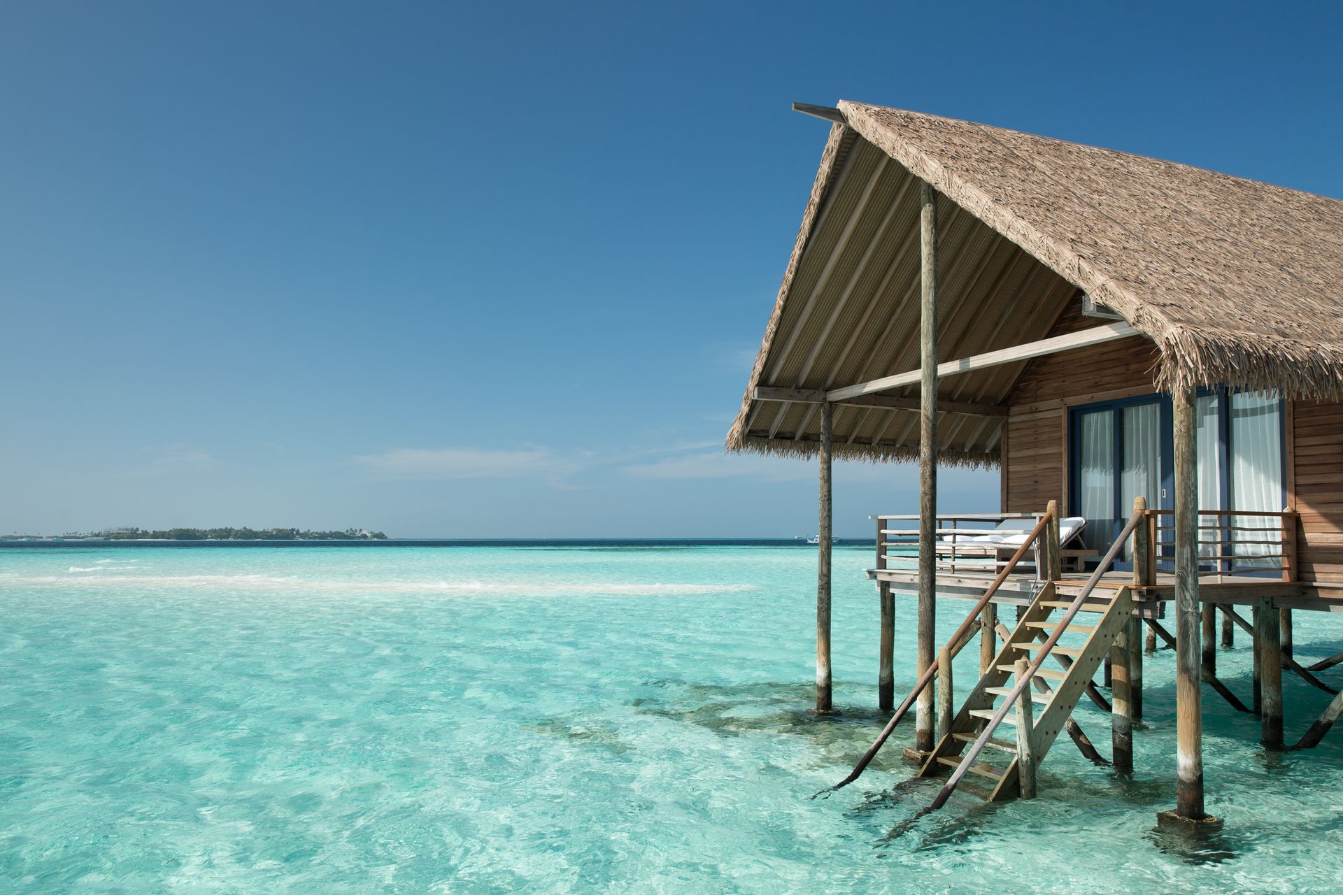 An overwater bungalow on stilts in the Maldives at como resort. 