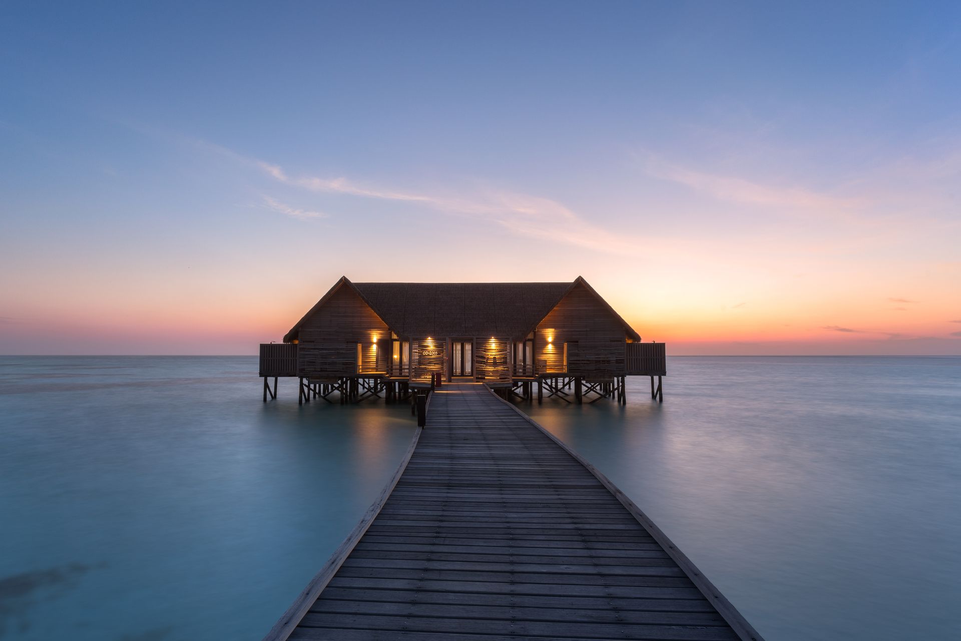 There is an overwater bungalow on stilts in the Maldives at a Como resort. 