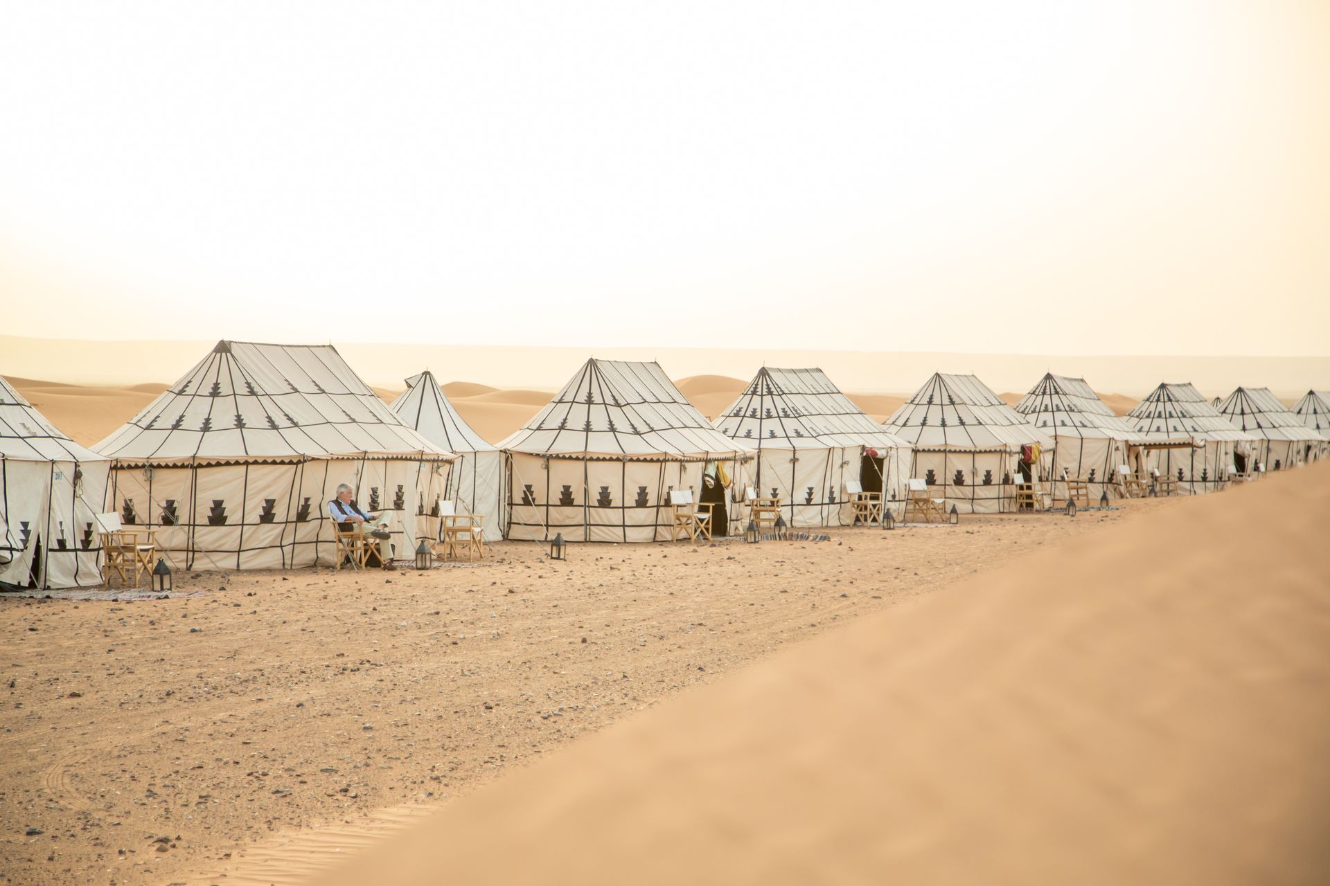 A row of tents in the middle of a desert in Morocco.