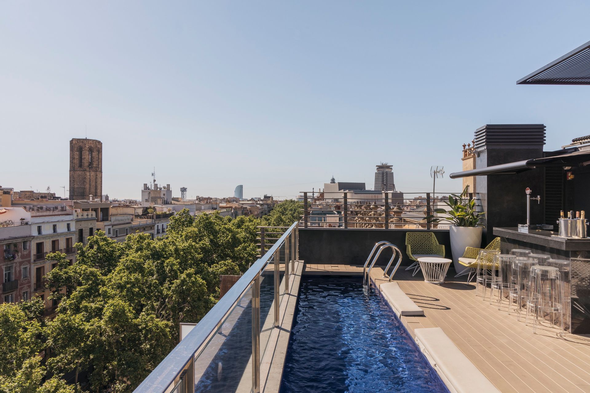 A swimming pool on a rooftop with a view of Barcelona, Spain at Hotel Bagués.