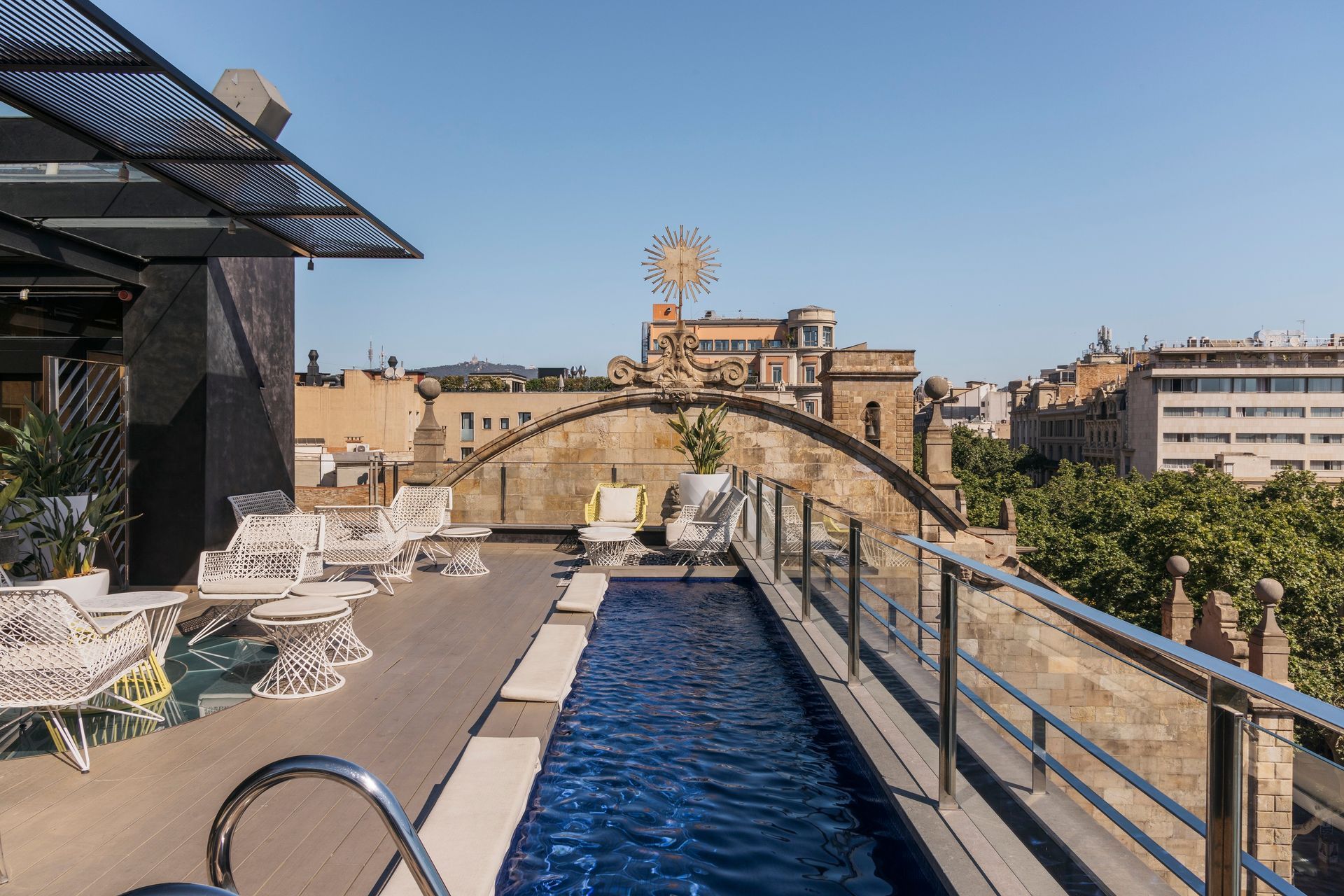 There is a large swimming pool on the roof of a building at Hotel Bagués in Barcelona, Spain.