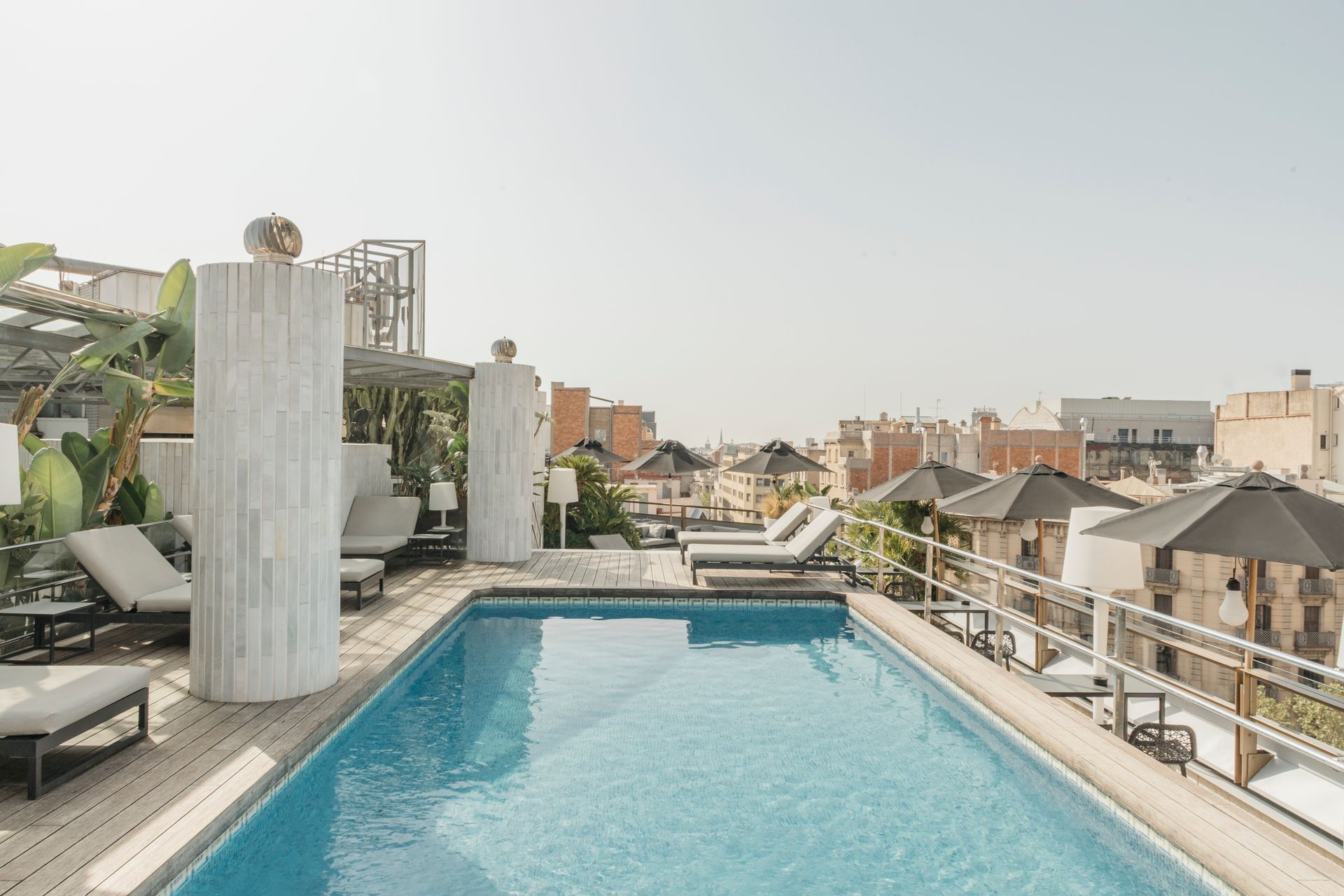 There is a large swimming pool on the roof of a building at Claris Hotel & Spa in Barcelona, Spain