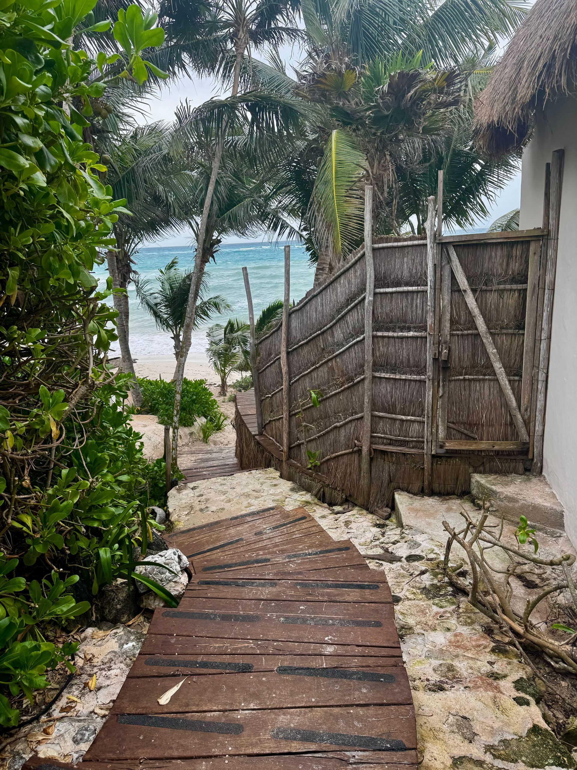 There is a wooden path leading to the beach at Papaya Playa Project hotel in Tulum, Mexico.