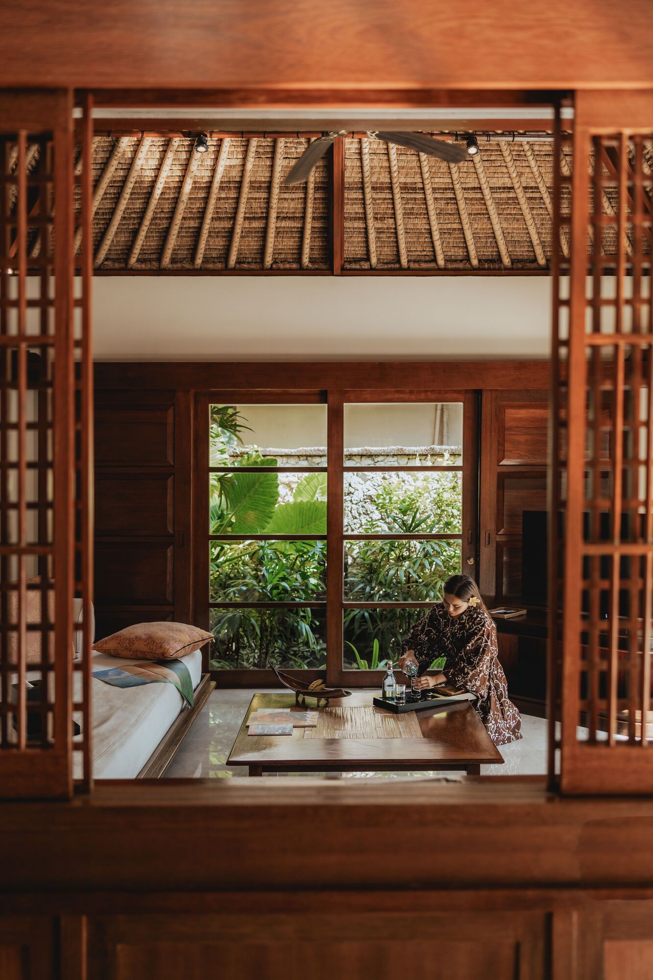 A woman is sitting at a table in a living room at villa in Bali.