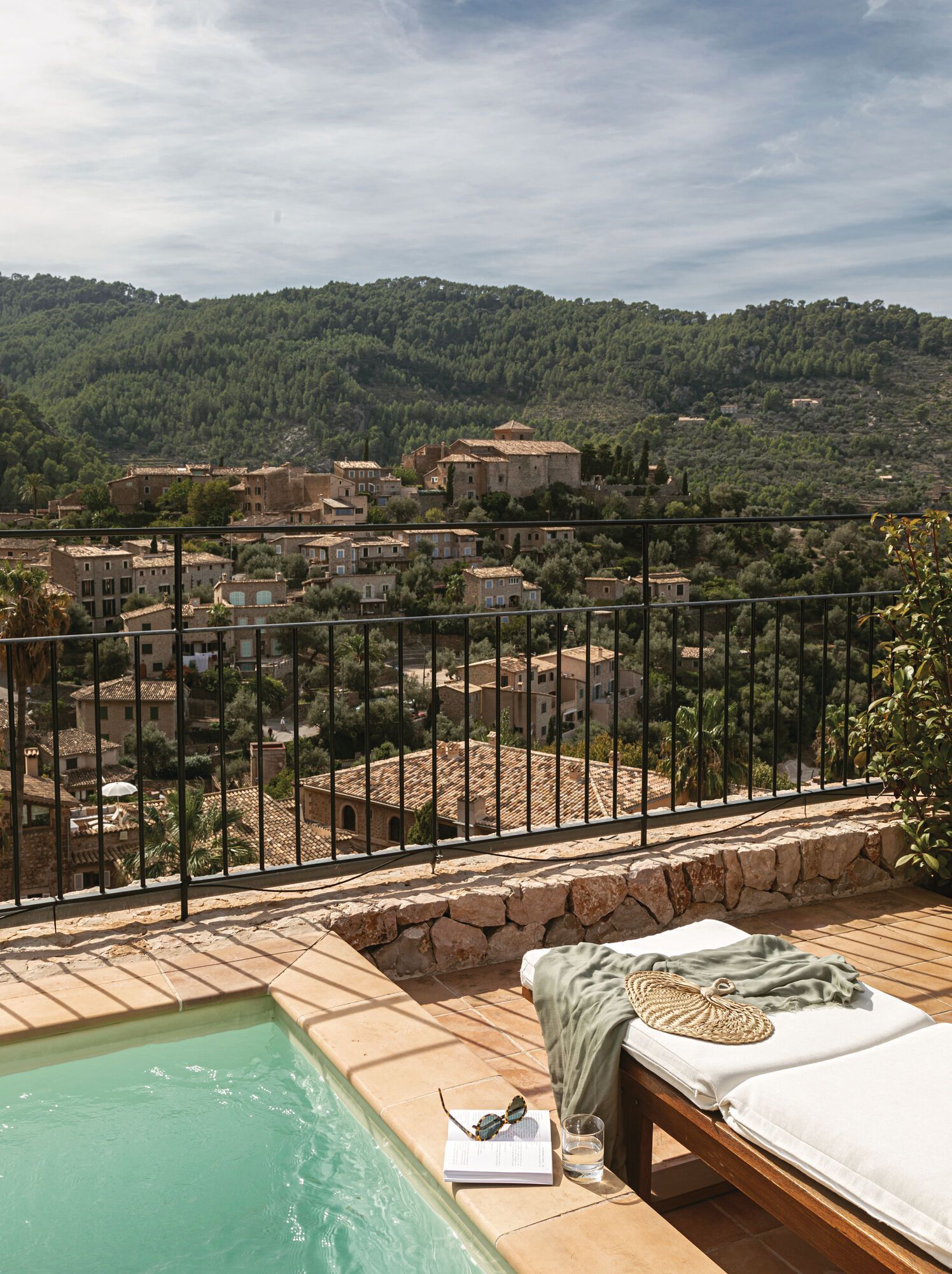 A swimming pool at belmond hotel with a view of the city and mountains of Mallorca, spain