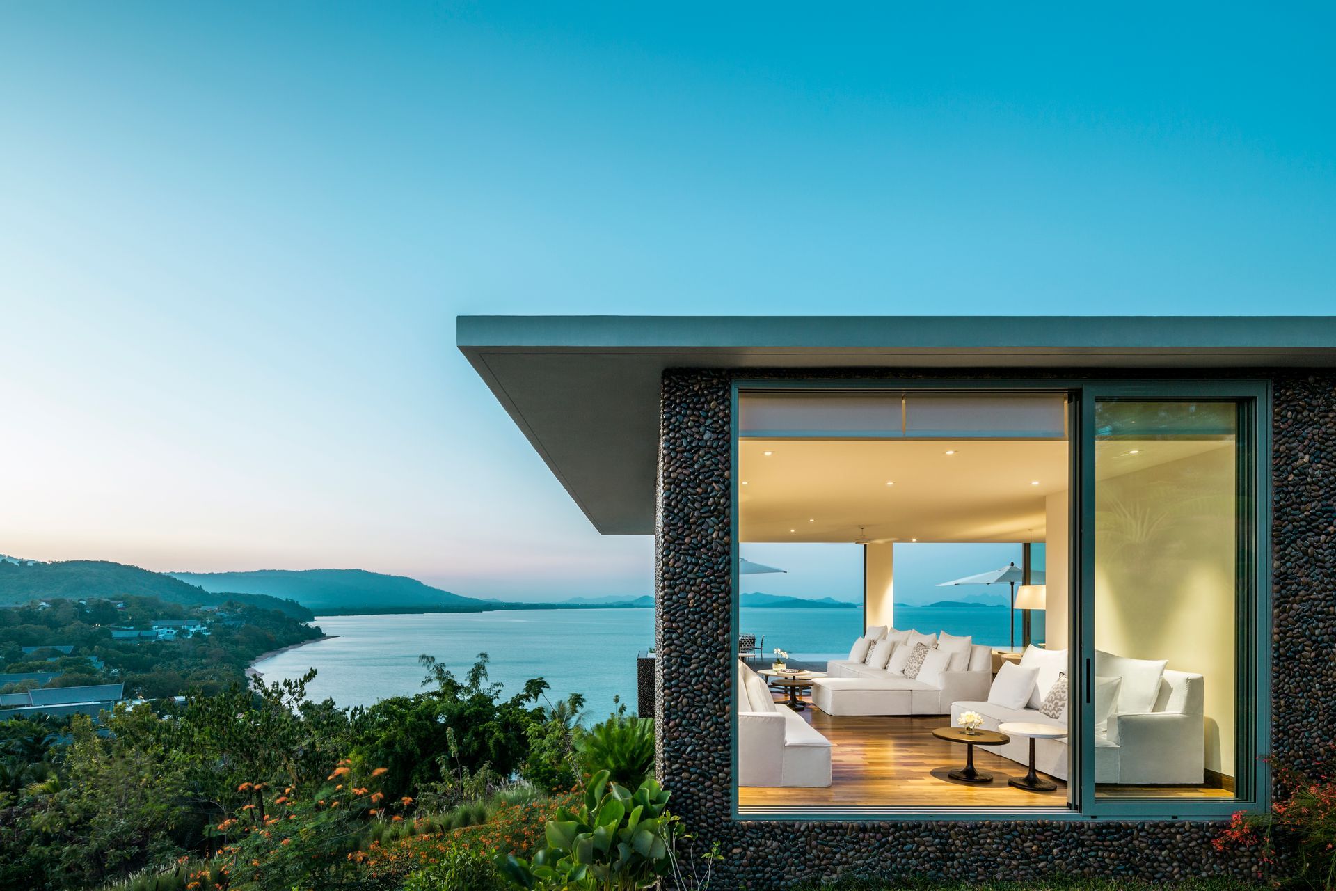 A modern house with a view of the ocean and mountains in Phuet, Thailand at Como Hotel. 