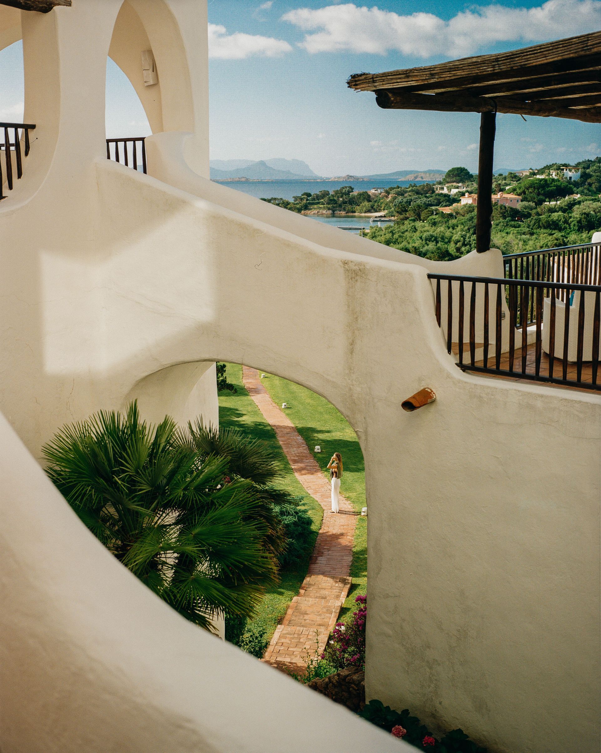 Belmond's hotel white building with stairs leading up to a balcony in Sardinia, Italy. 