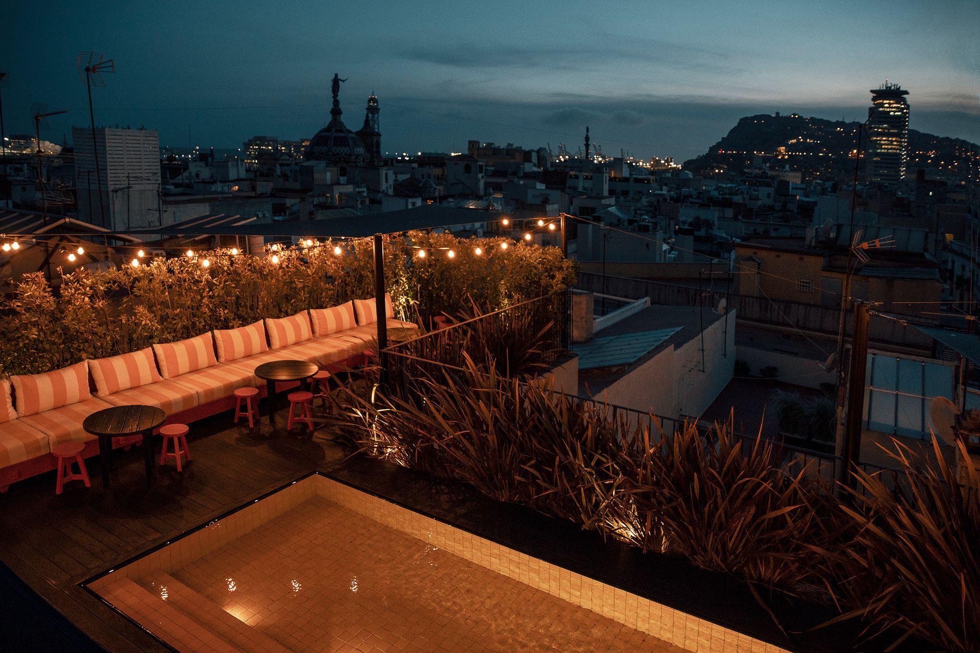 There is a swimming pool on the roof of a building at Wittmore Hotel in Barcelona, Spain.