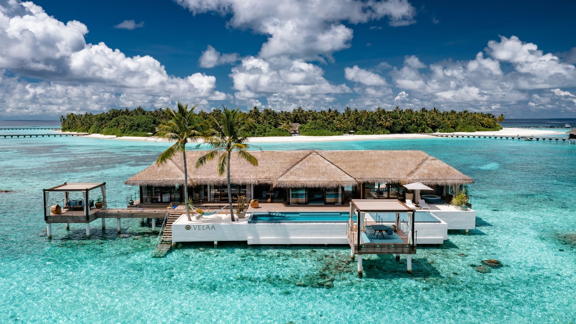 An overwater bungalow is floating in the middle of the Maldives at vella resort.