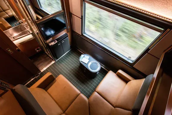 A room with a couch and a table on VIA Rail’s train.