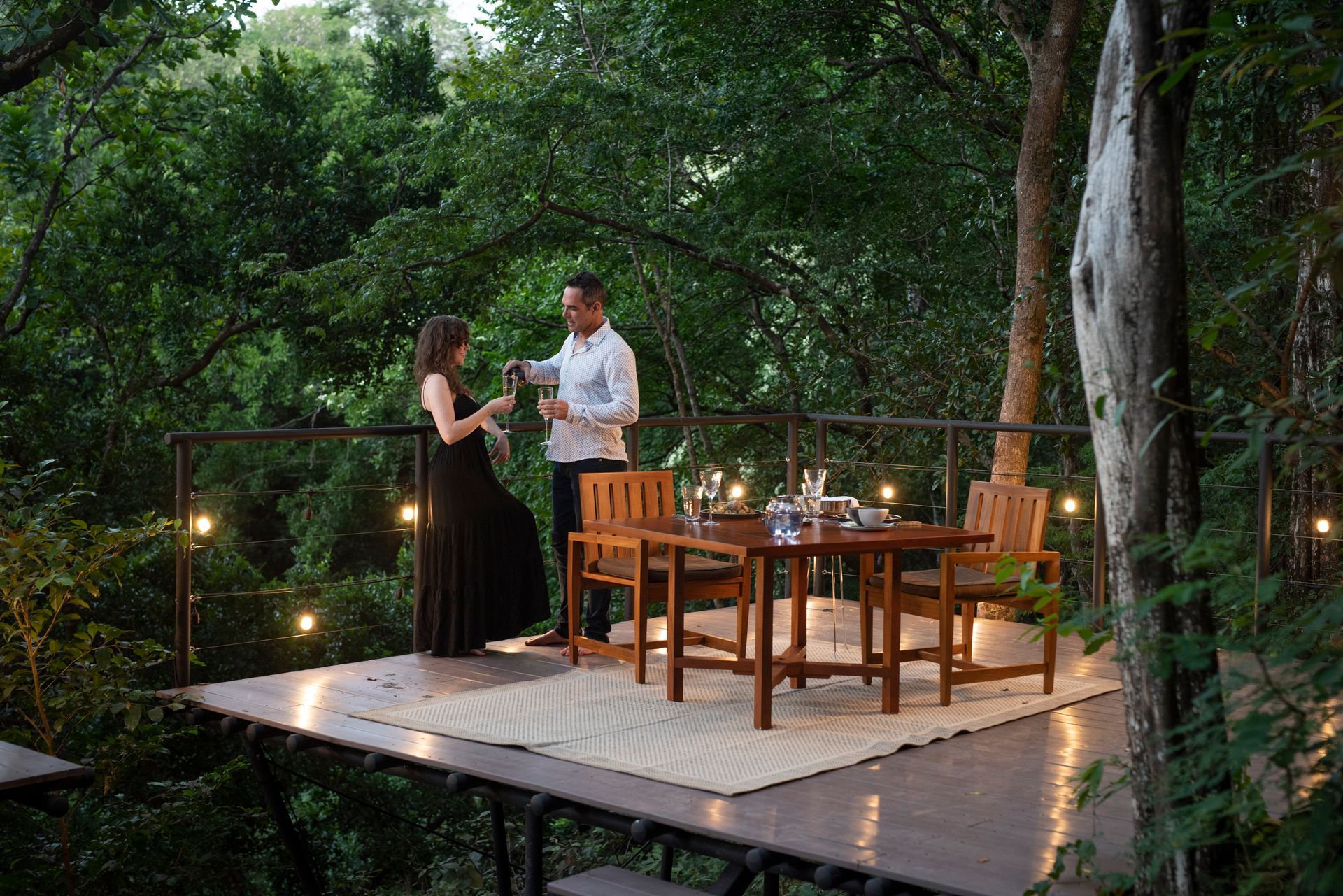 A man and a woman are sitting at a table in the jungle in Costa Rica.