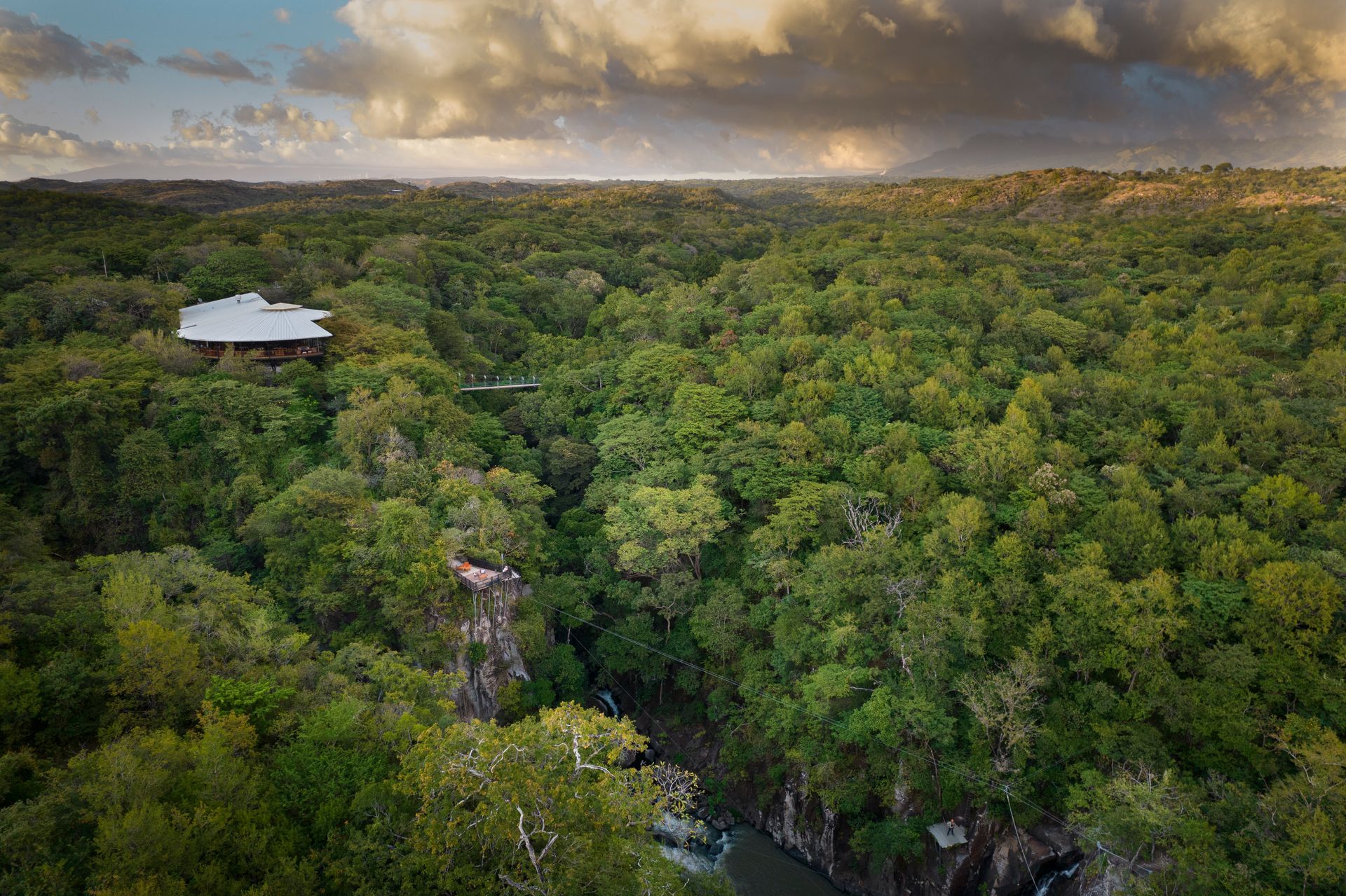 An aerial view of a tree house in the middle of a lush jungle in Costa Rica.