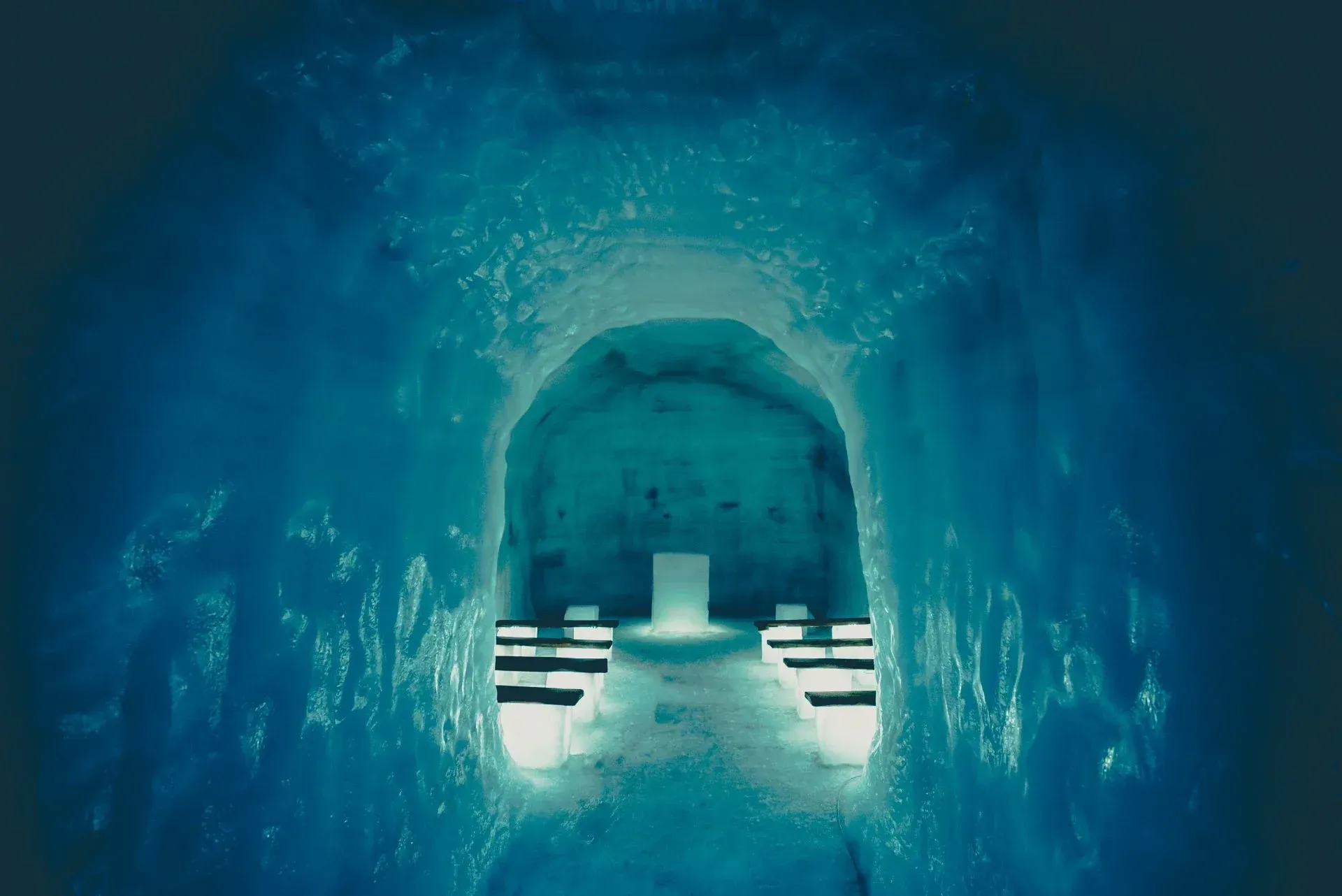A dark blue tunnel with a light at the end of it.