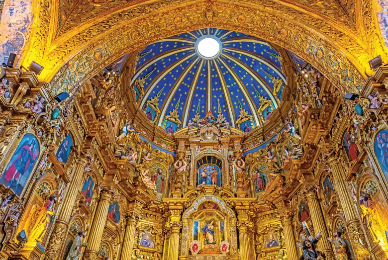 The inside of a church with a dome on top of it.