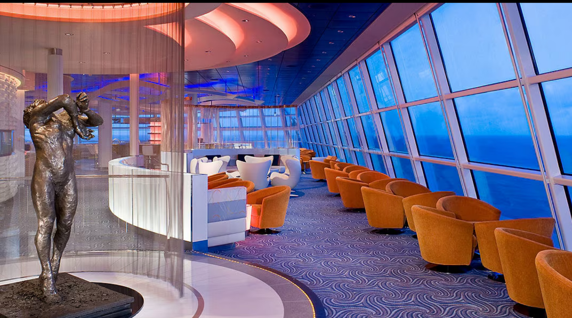 A statue in a room with a lot of windows on the Celebrity Equinox cruise ship.