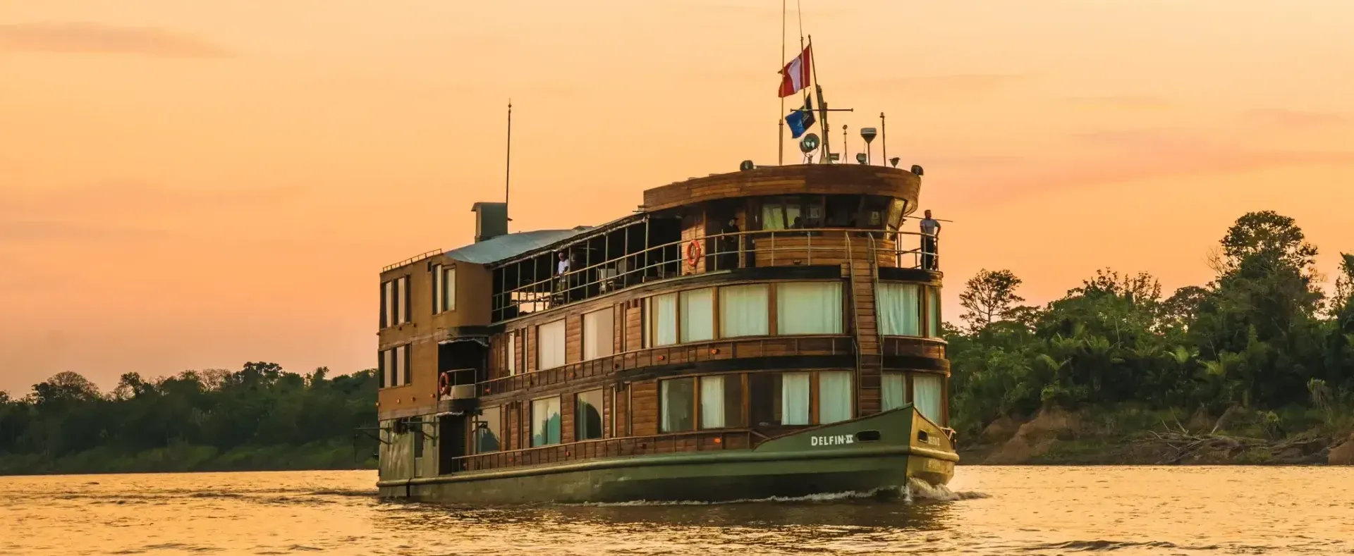 Lindblad's Delfin II Expedition Cruise Ship is floating on top of the Amazon River.