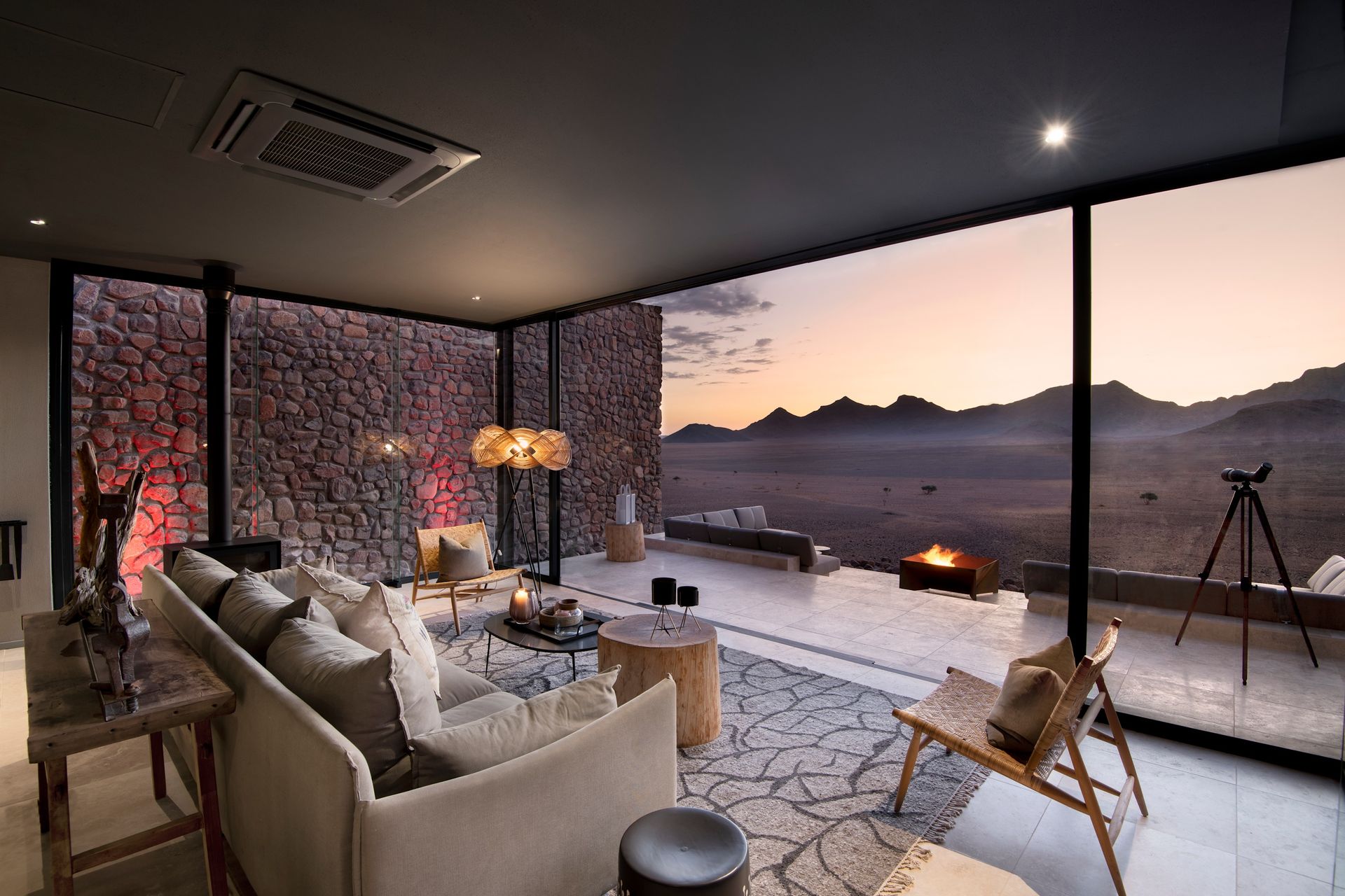 A living room with a view of the desert at a lodge in Africa.