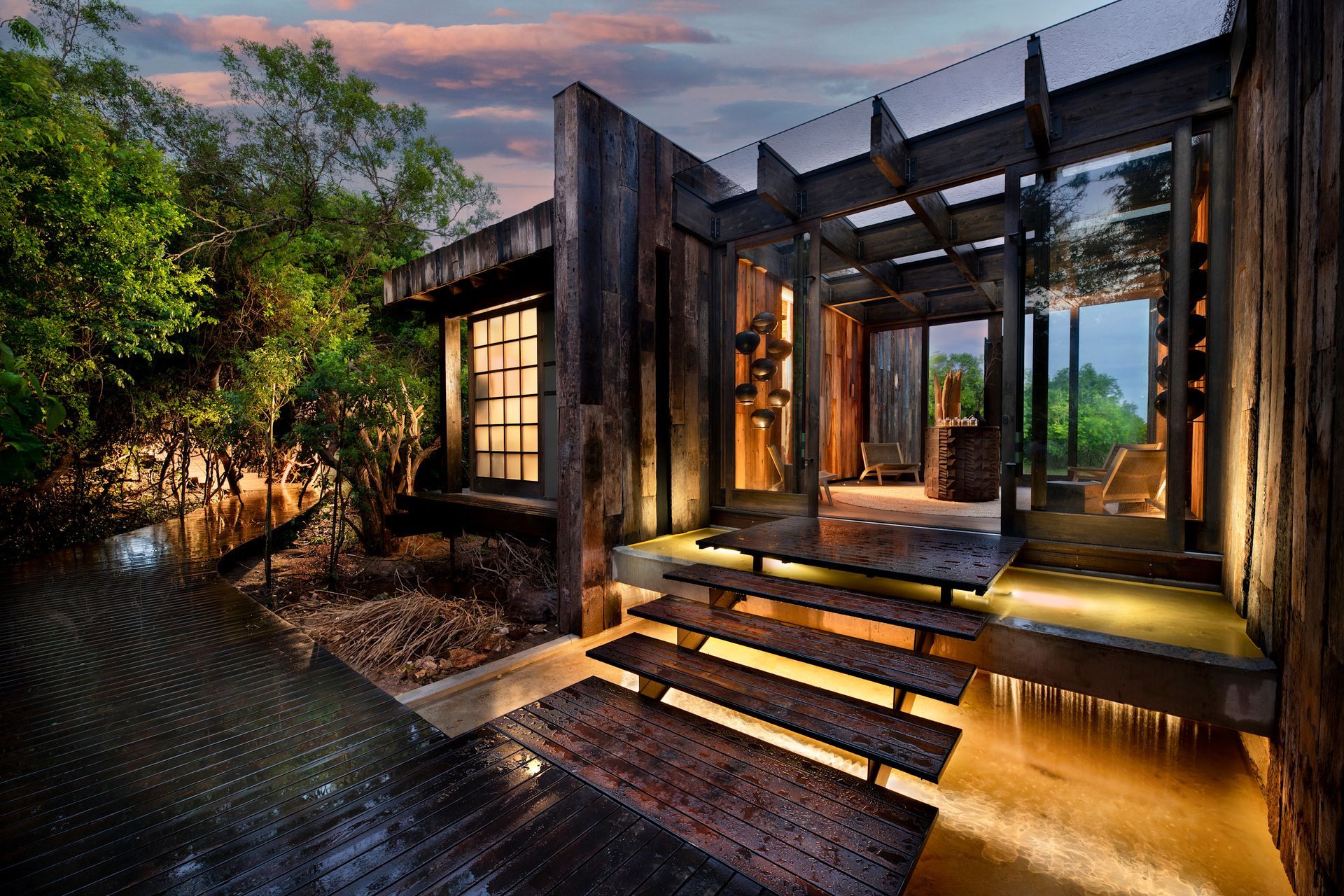 A wooden lodge with stairs leading up to it in Africa.