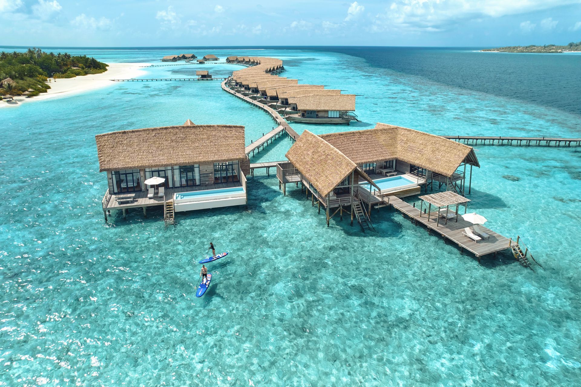 An aerial view of an overwater bungalow at Como Resort in the Maldives. 