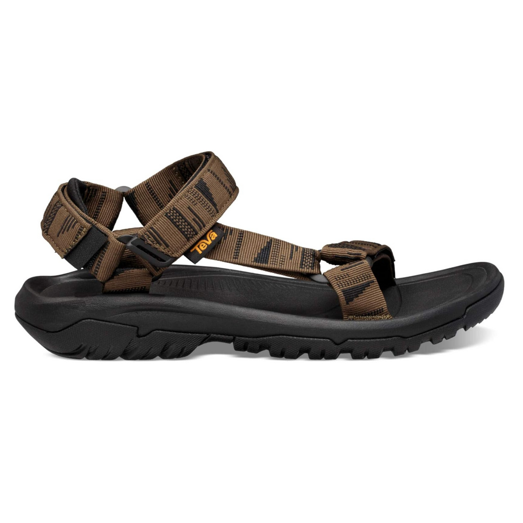 A pair of brown and black teva sandals on a white background.