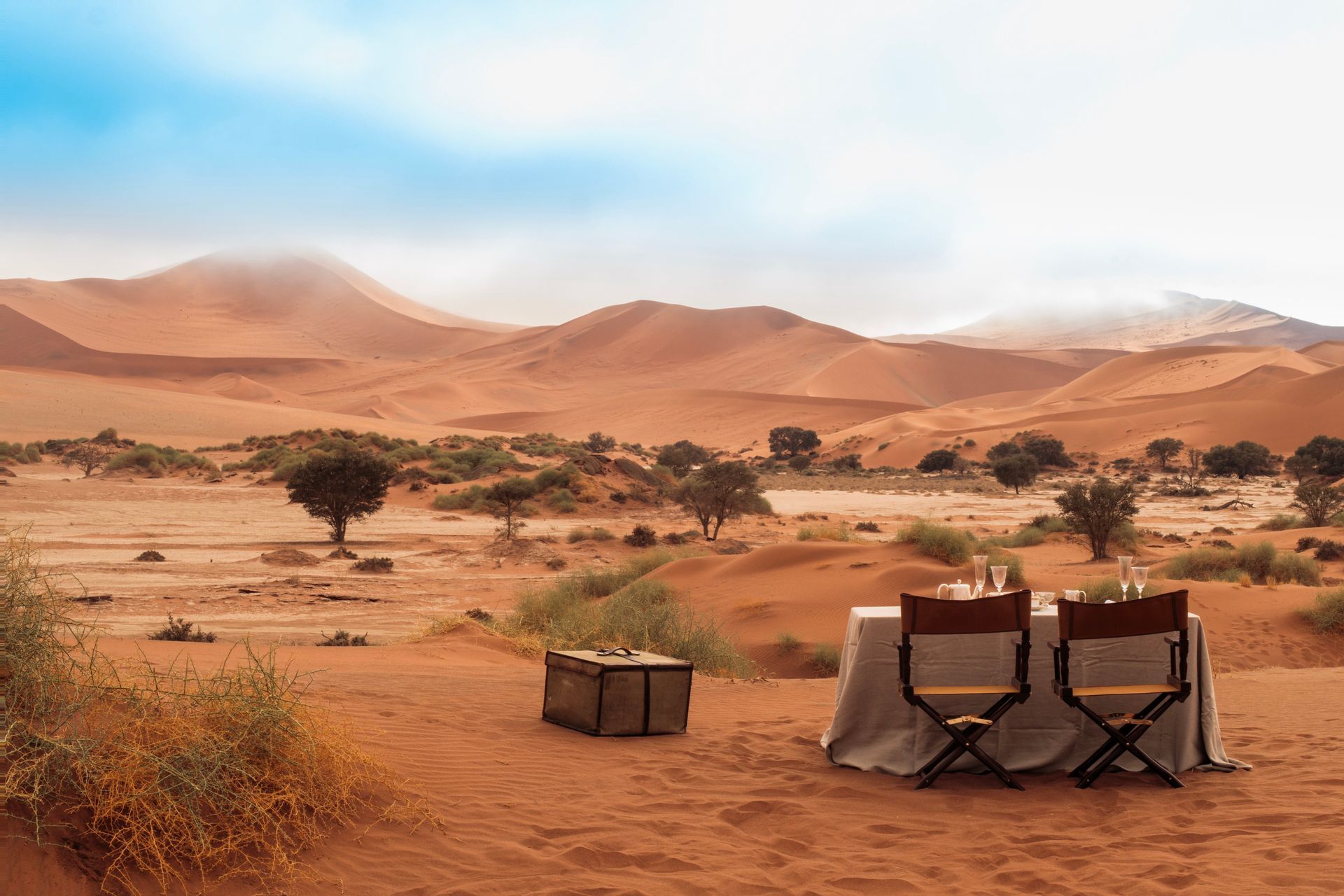 There is a table and chairs in the middle of the desert at a camp in Namibia, Africa.