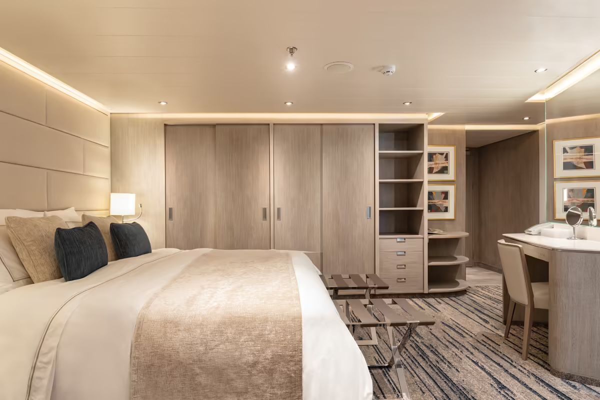 There is a large bed in the middle of the room on Silversea's Silver Origin Expedition Cruise Ship.