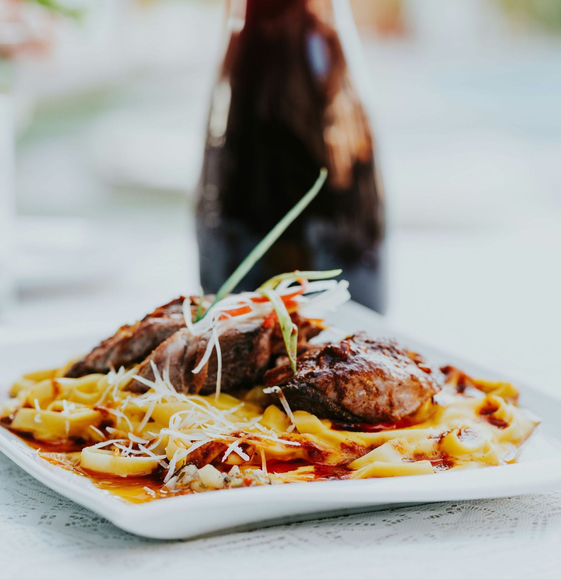 A plate of traditional Peruvian food with a bottle in the background in Peru.