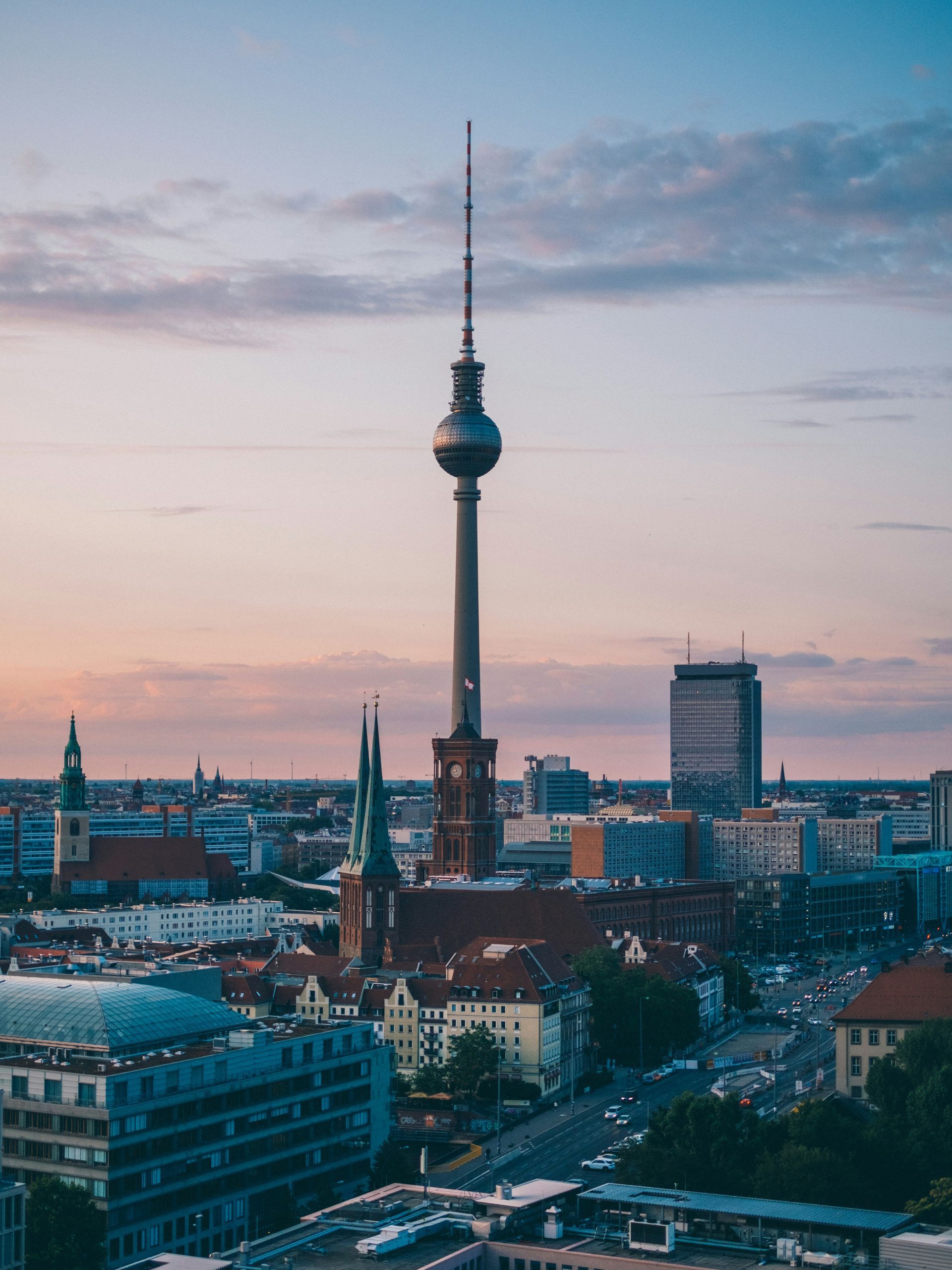 Berlin cityscape with the TV Tower dominating the skyline at sunset.