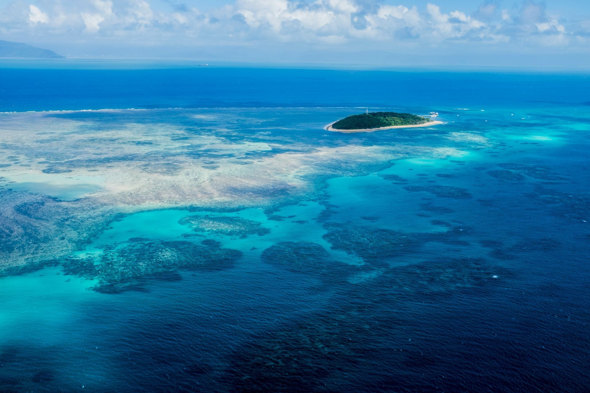 An aerial view of the Great Barrier Reef in the middle of the ocean in Australia.