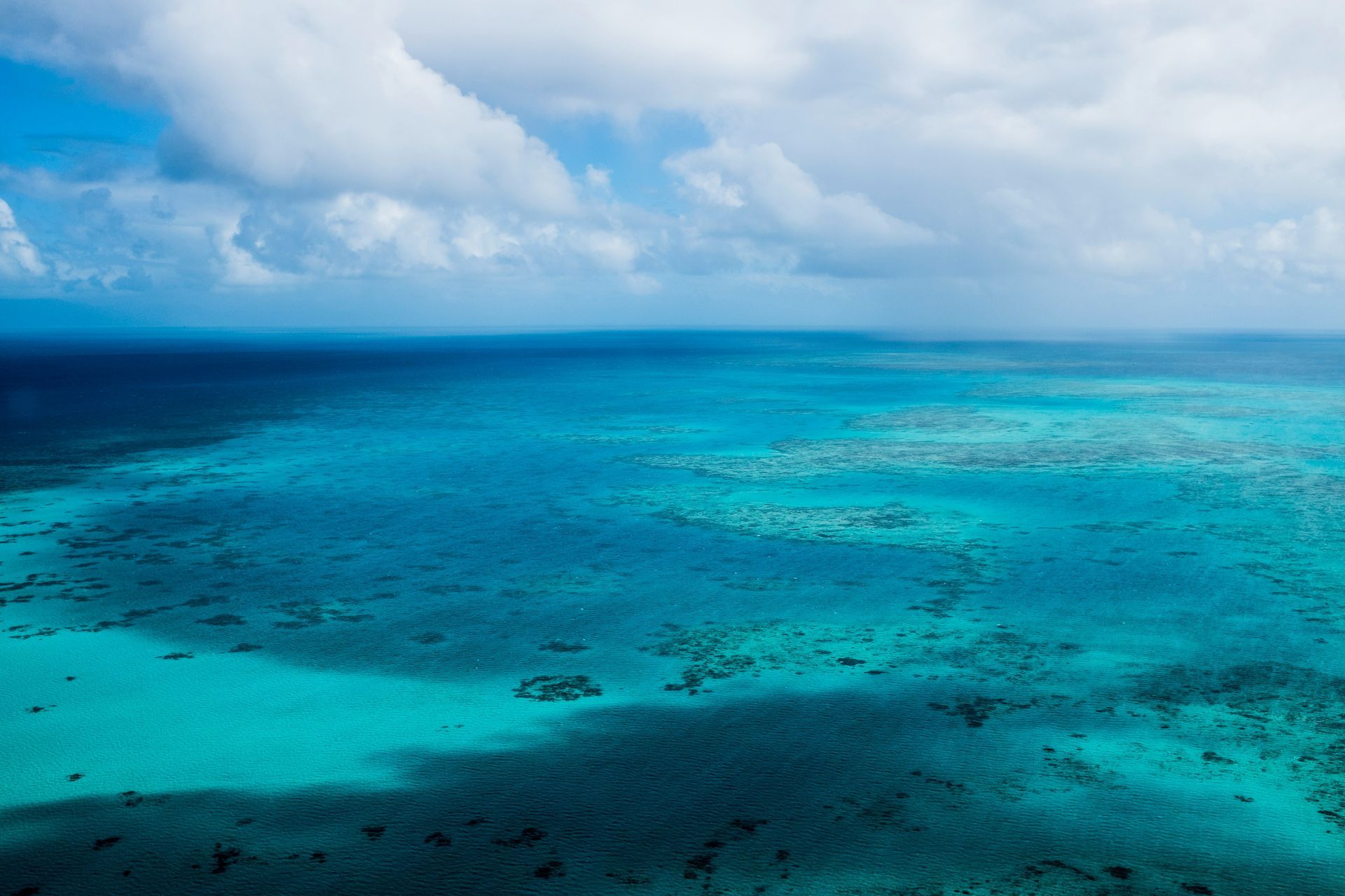An aerial view of the Great Barrier Reef in the middle of the ocean in Australia.