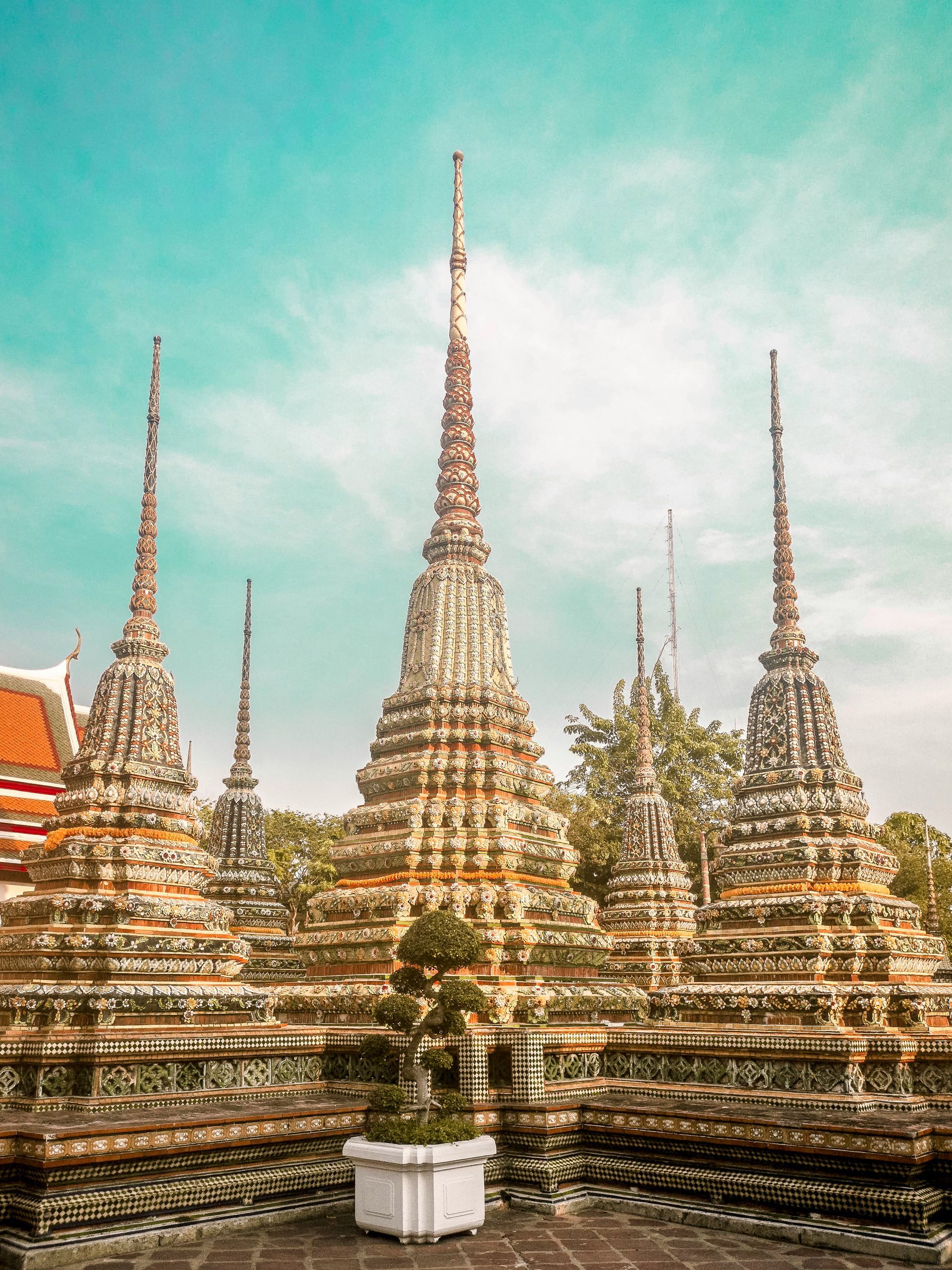 A row of temples with a blue sky in the background in Bangkok, Thailand.
