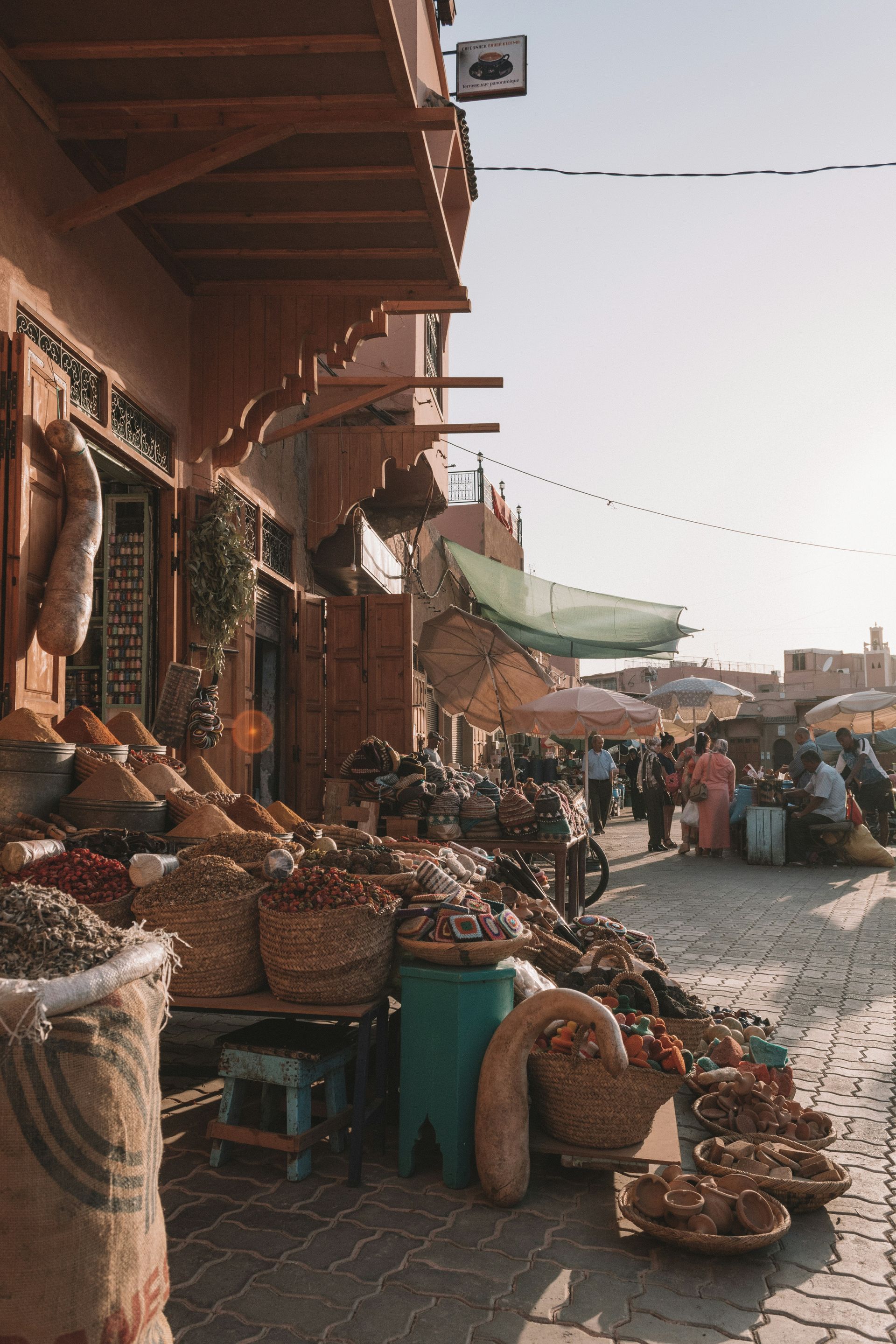 A street filled with lots of baskets and bags of food in Marrakesh, Morocco.