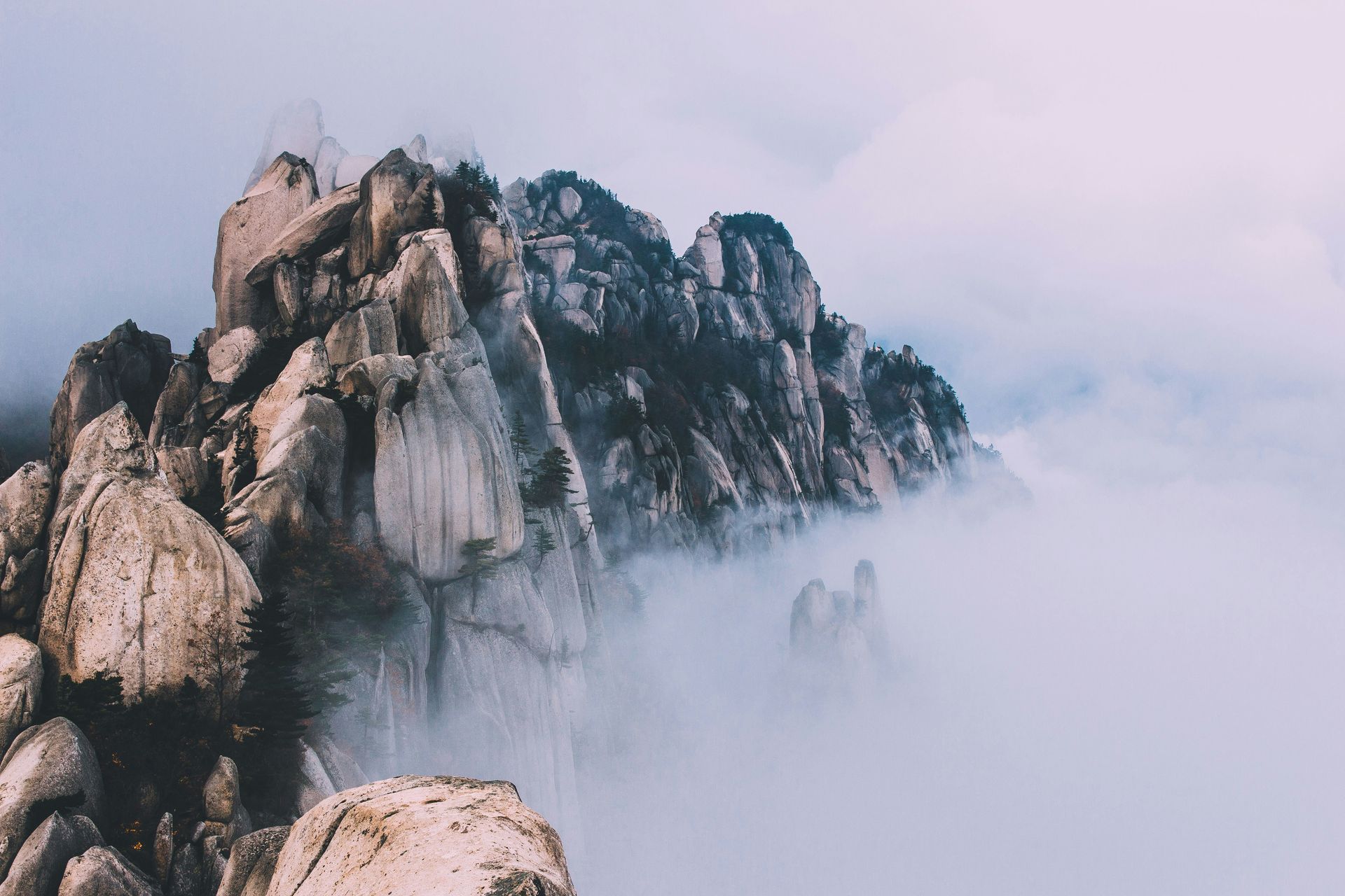 Rocky mountain peaks emerging from a sea of clouds in Seoraksan National Park, South Korea.