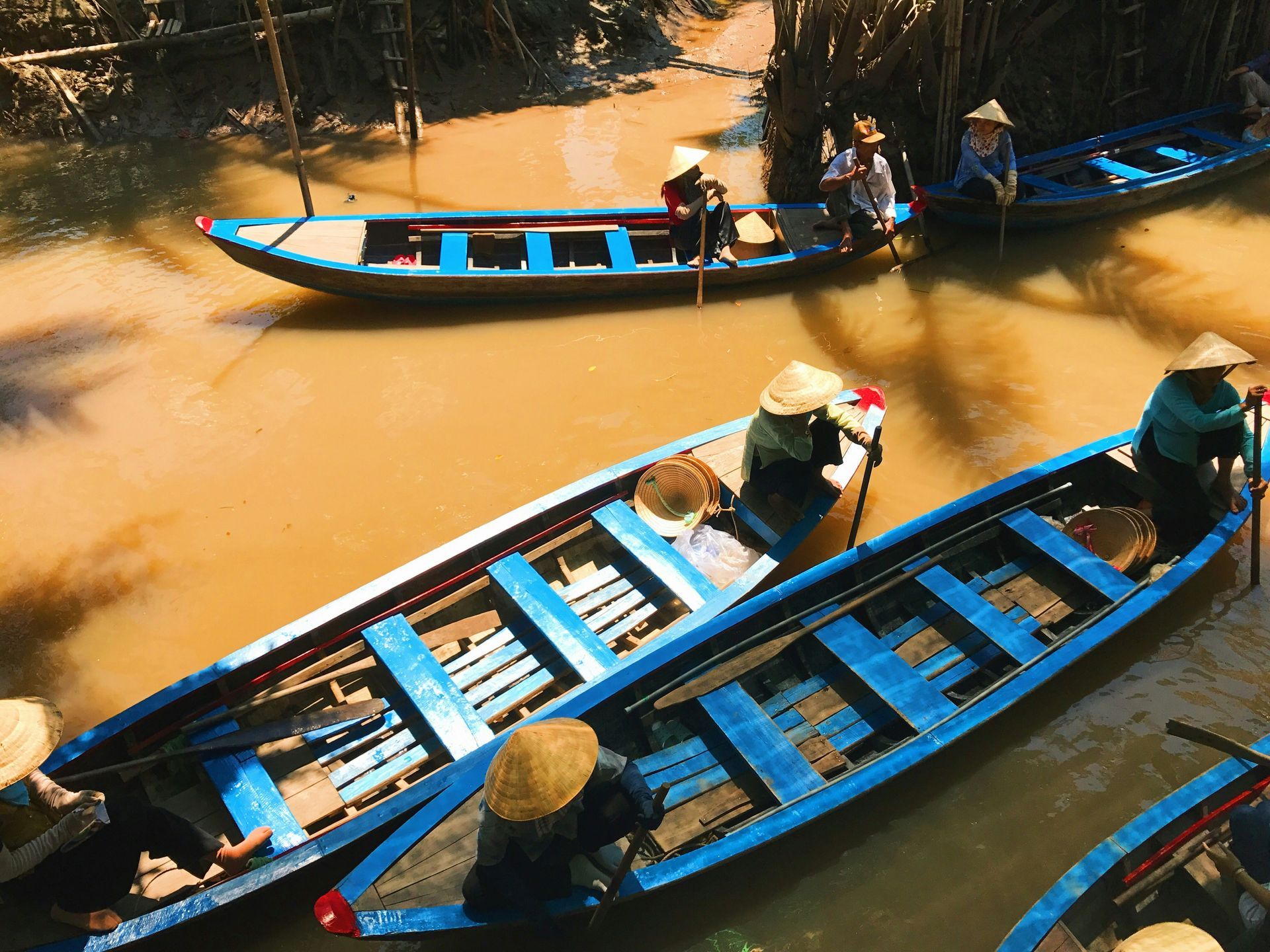 Boats with people in conical hats on the Mekong River.