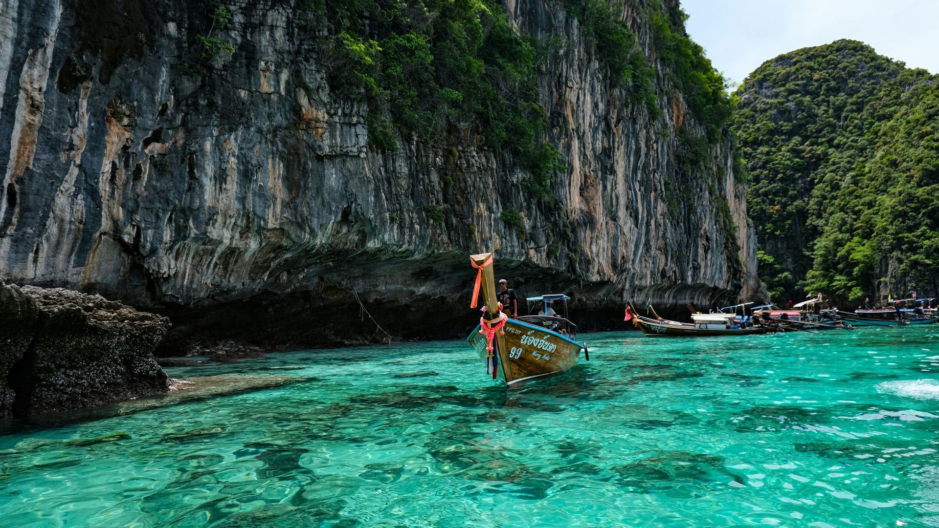 A boat is floating on top of a body of water at the Phi Phi Islands in Krabi, Thailand.