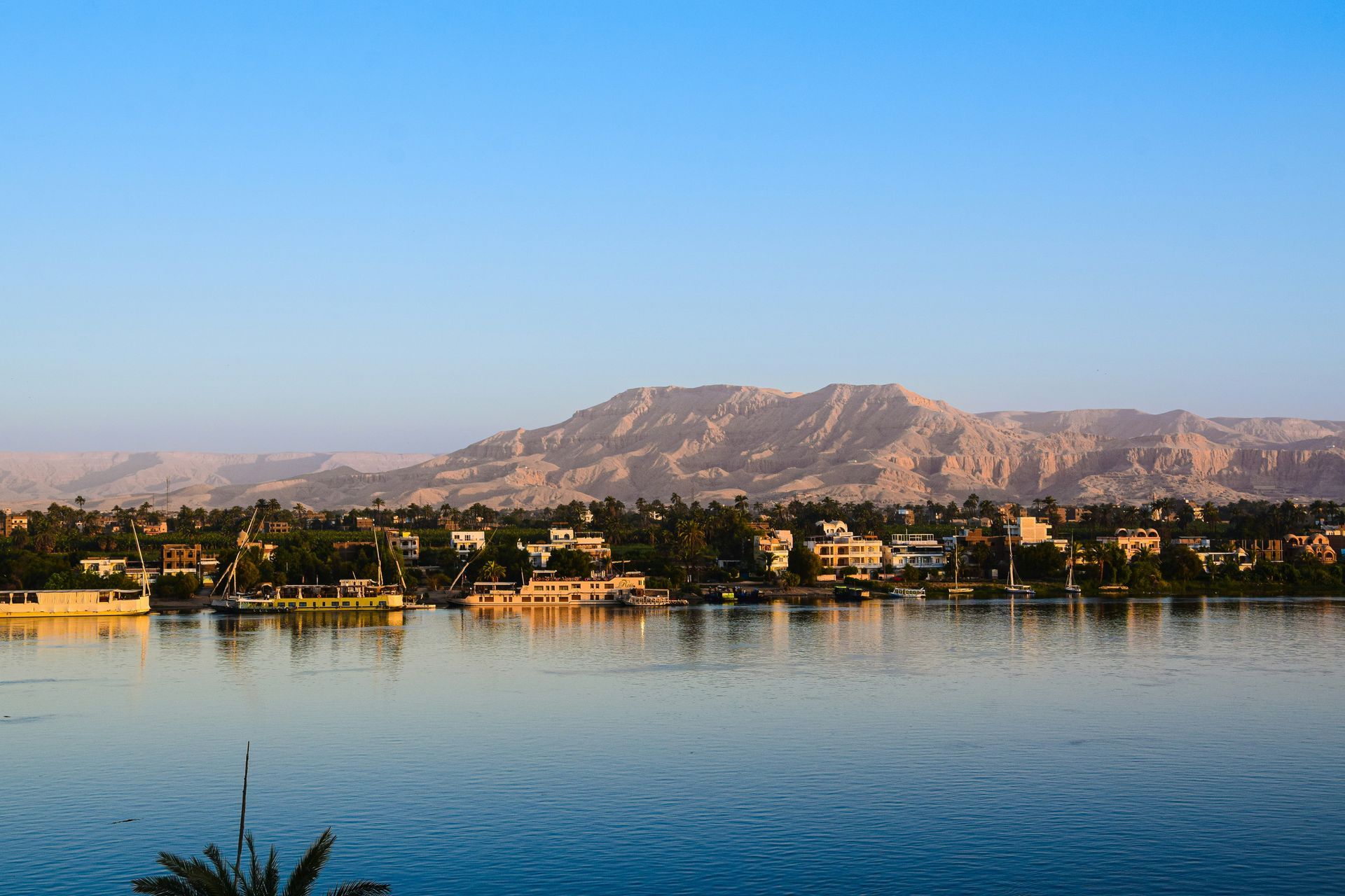 A lake with mountains in the background and Luxor, Egypt in the foreground.
