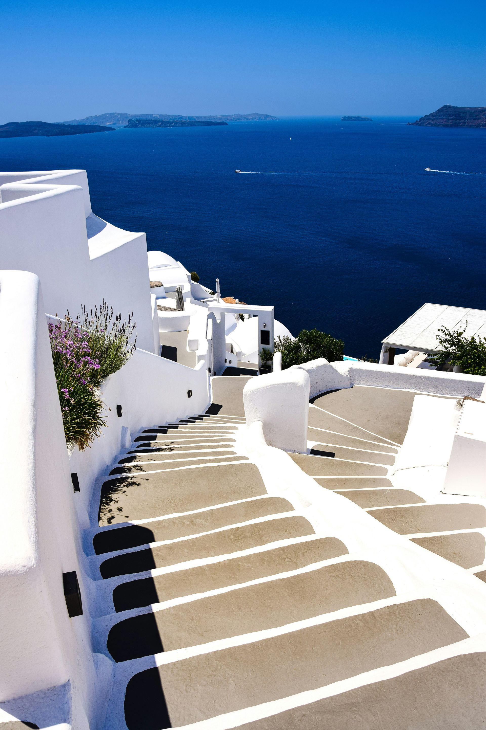 A set of stairs leading up to the ocean in Santorini, Greece.