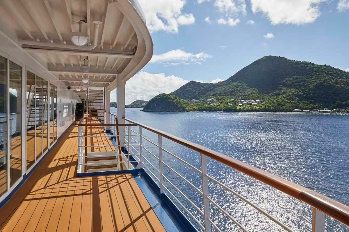 The deck of Silversea's Silver Whisper cruise ship with mountains in the background