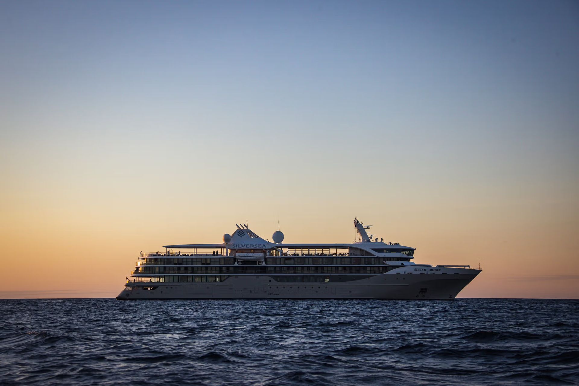Silversea's Silver Origin Expedition Cruise Ship is floating on top of a large body of water.
