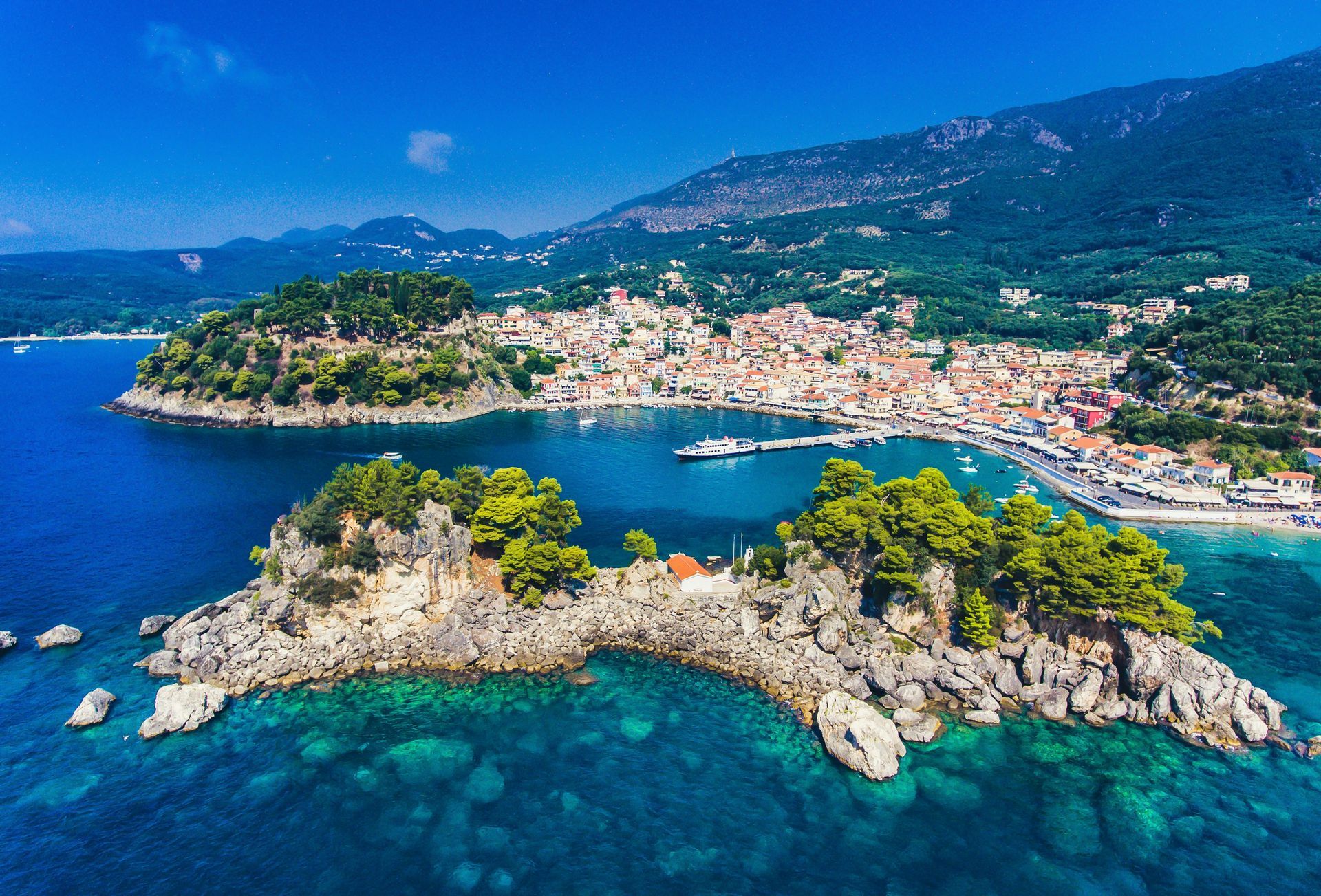An aerial view of Parga, Greece, surrounded by the ocean and mountains.