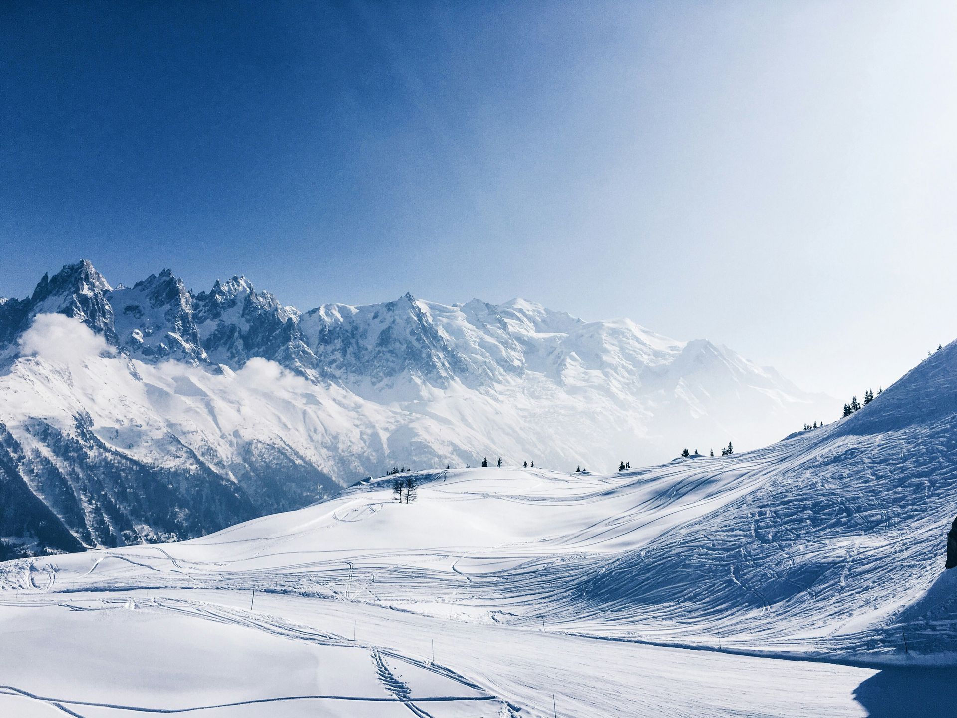 A group of people are skiing down a snow covered mountain in Chamonix, France.